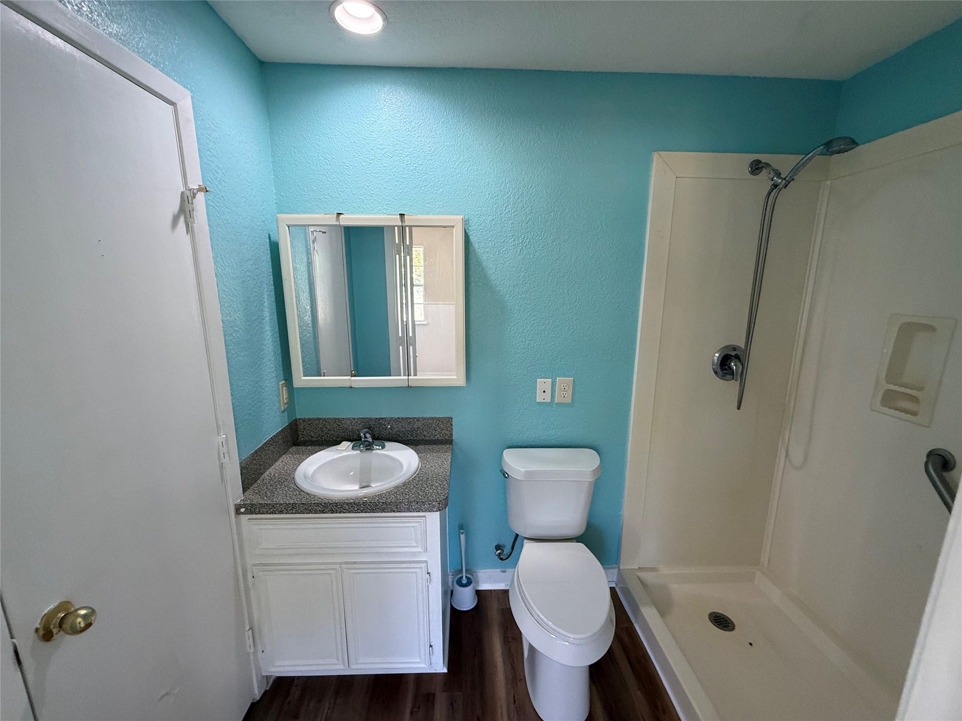 2524 Shouse Road, Santa Fe, TX 77510 Bathroom featuring a white vanity, mirrored cabinet, and tub/shower combination.