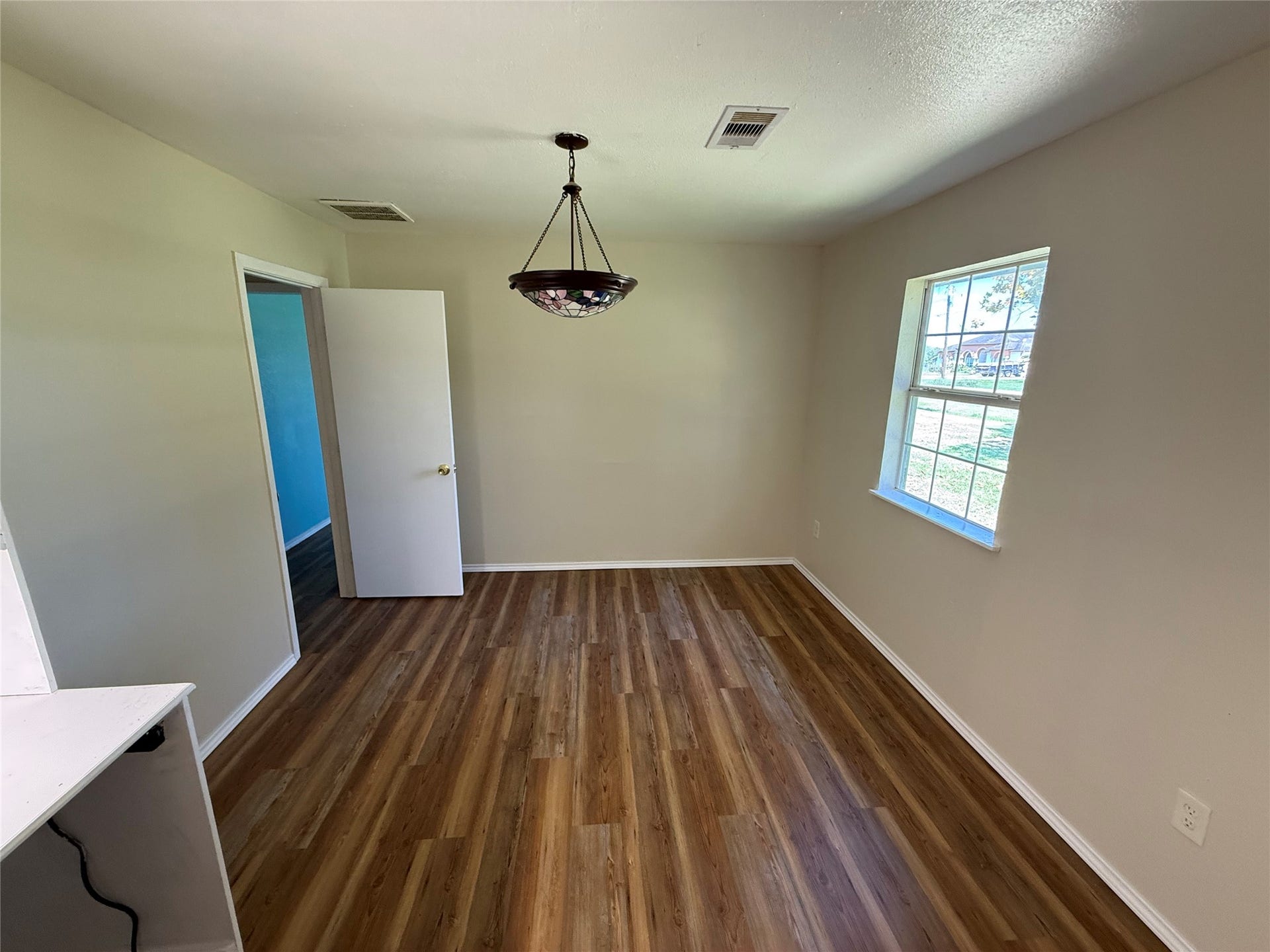 2524 Shouse Road, Santa Fe, TX 77510 Room with wood-look flooring, a ceiling fan, and a large window.