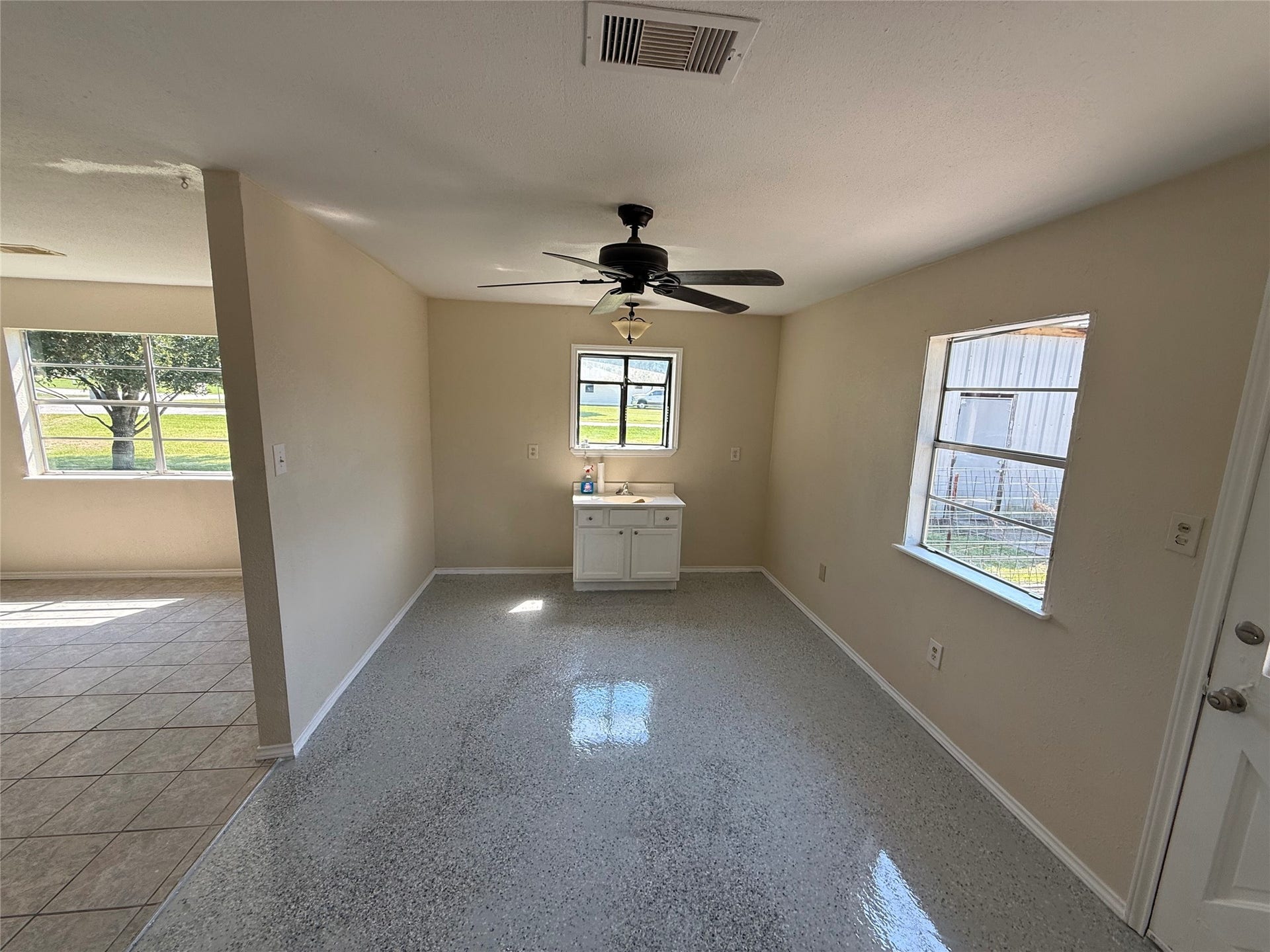 2524 Shouse Road, Santa Fe, TX 77510 Bright gathering space with tile flooring, multiple windows, and a ceiling fan.