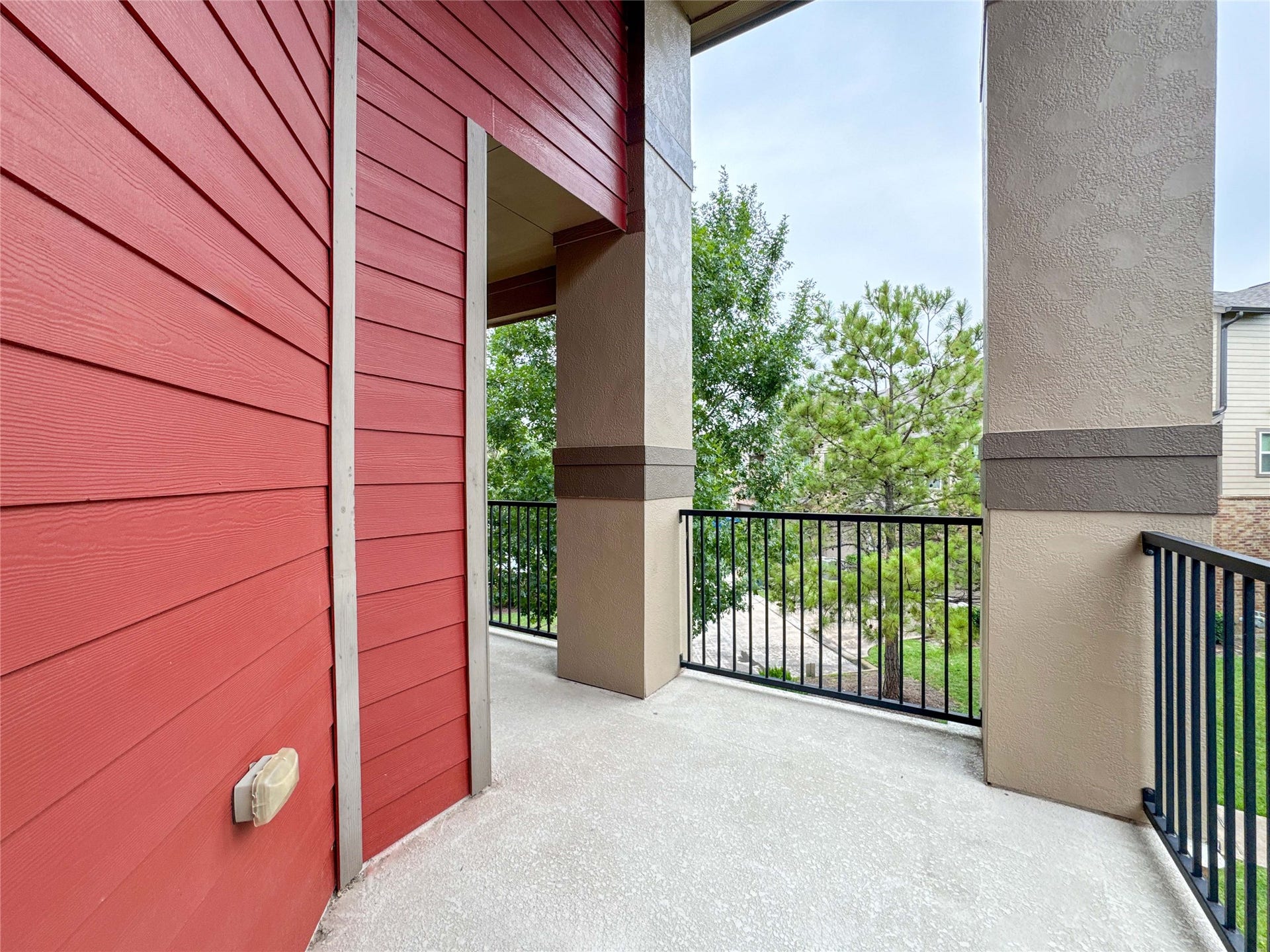 This townhome is an end unit that features a cozy balcony with access to the primary bedroom. It's an inviting outdoor space for relaxation.