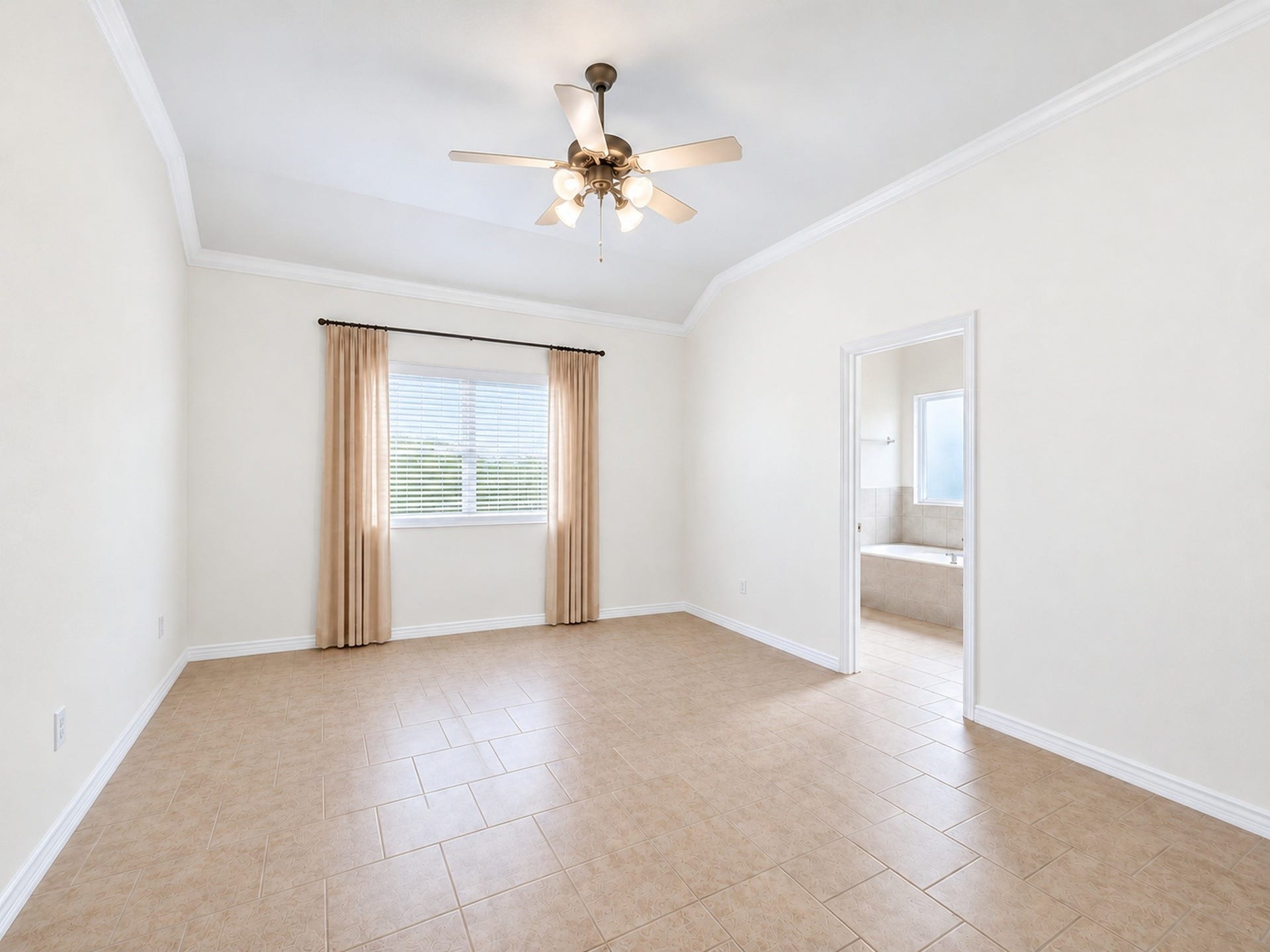 1902 Willow Ridge Lane, Fulshear, TX 77423 Unfurnished bedroom view shows the tray ceiling, ceiling fan, and adjoining bathroom access.