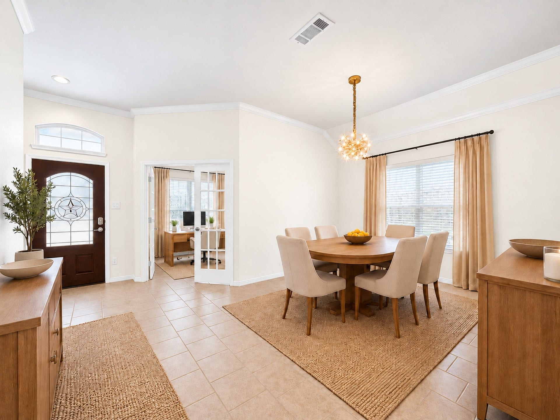 1902 Willow Ridge Lane, Fulshear, TX 77423 Virtually staged to illustrate the dining rooms layout and furnishing possibilities. Features include tile flooring, crown molding, a decorative chandelier, and a large window. French doors lead to an adjacent room.