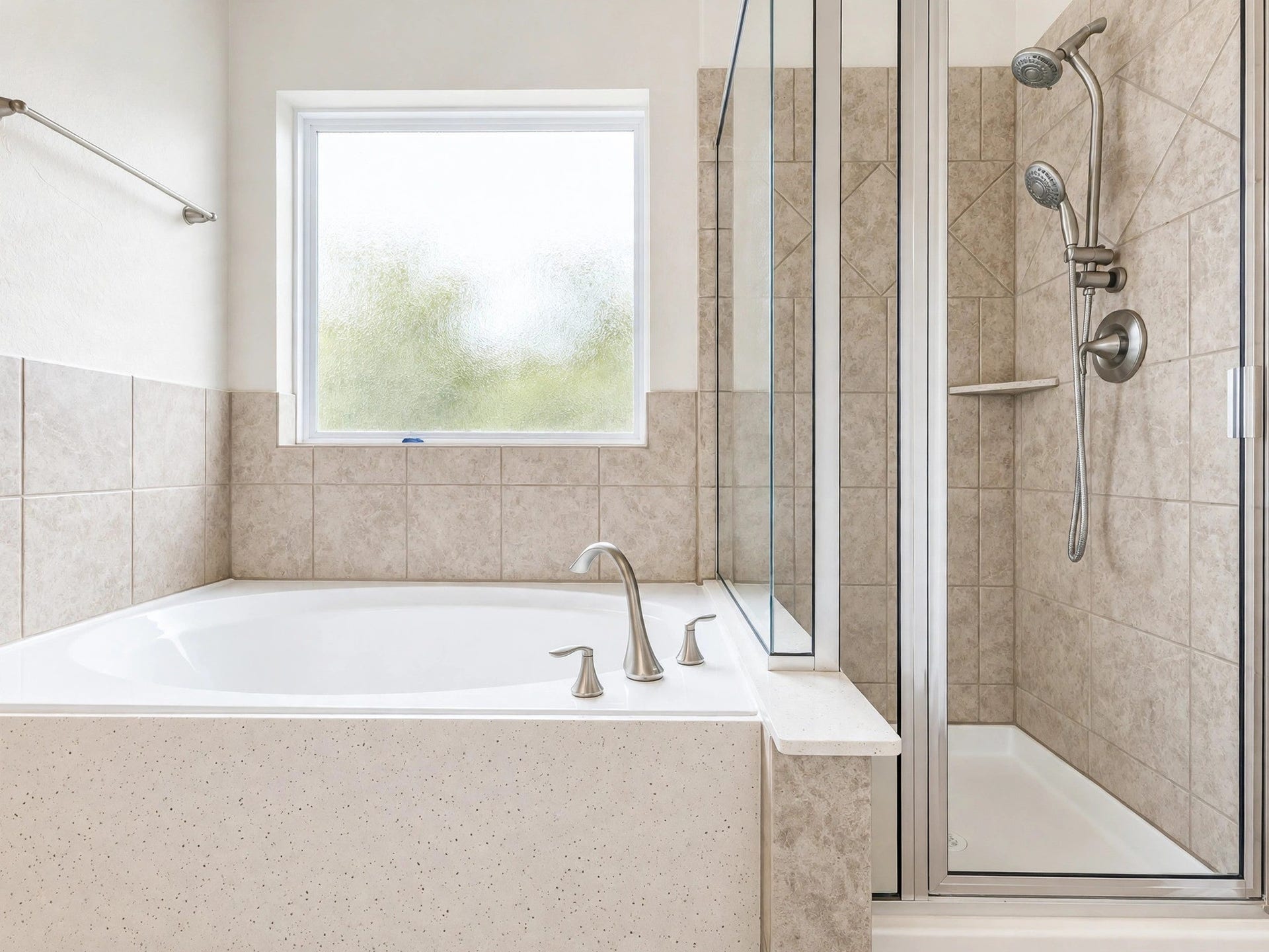 1902 Willow Ridge Lane, Fulshear, TX 77423 A soaking tub beneath a large window sits beside a separate glass-enclosed shower.