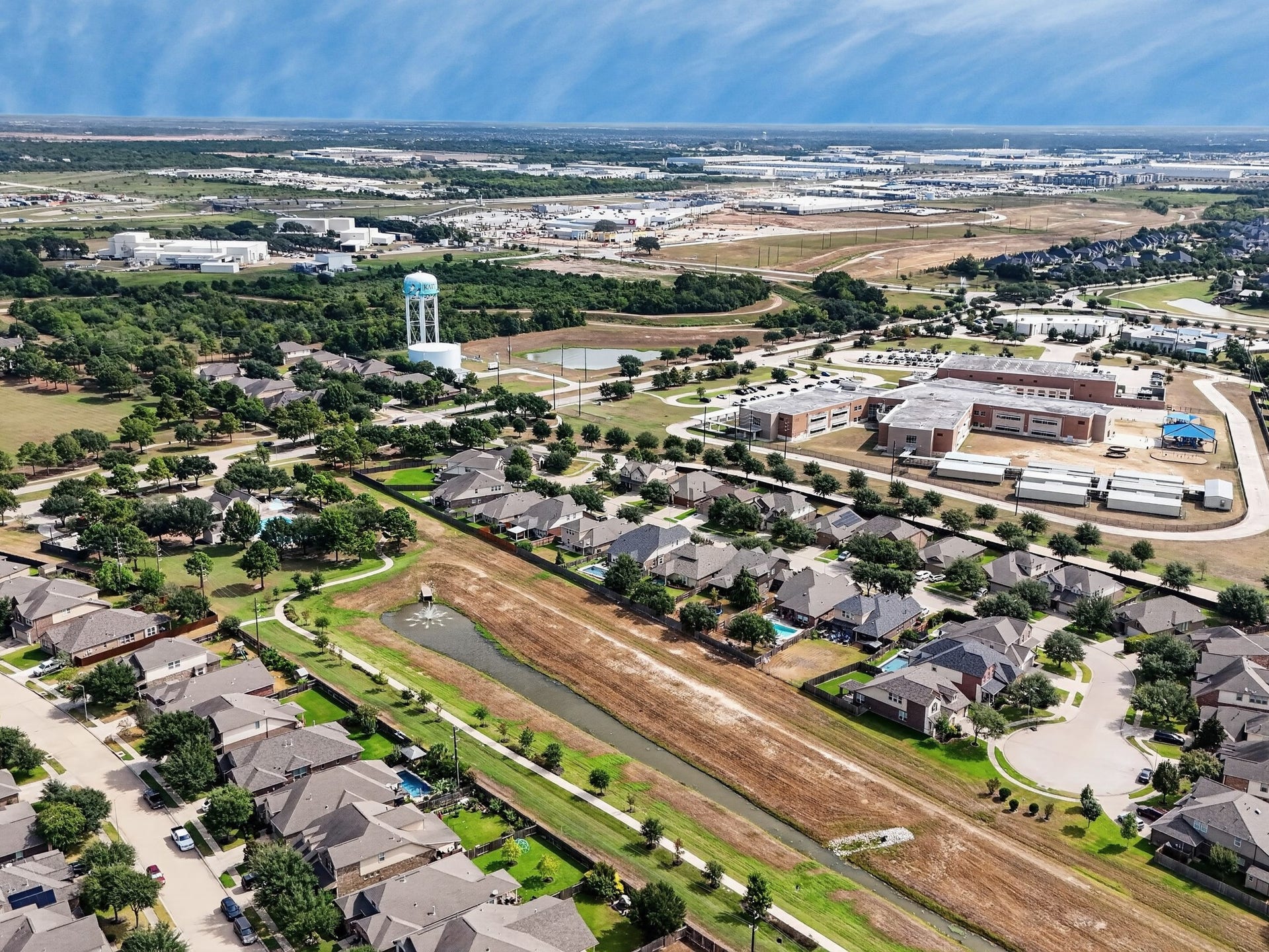 1902 Willow Ridge Lane, Fulshear, TX 77423 Aerial perspective provides a broader view of the surrounding neighborhood and nearby development.