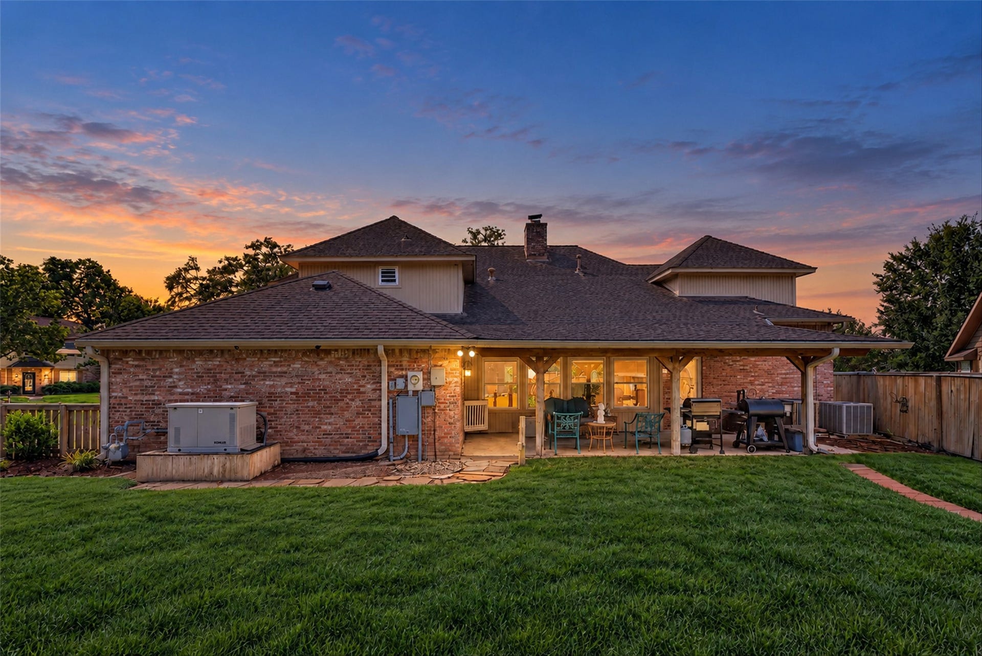 Twilight view of back patio area.  Note the  whole house generator.