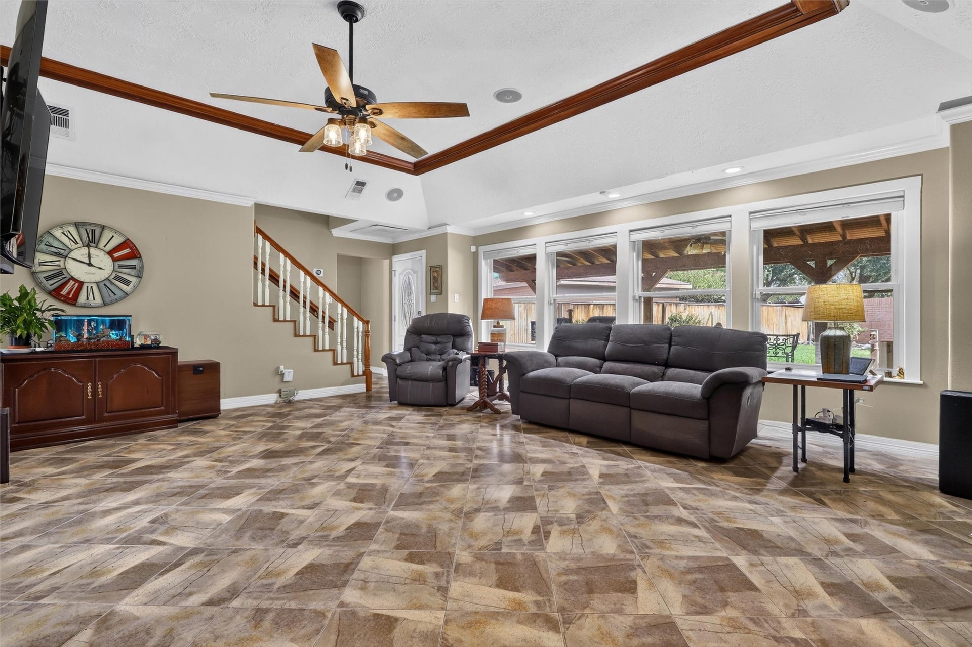 View of family room with stairs to upstairs and entry to downstairs bedroom