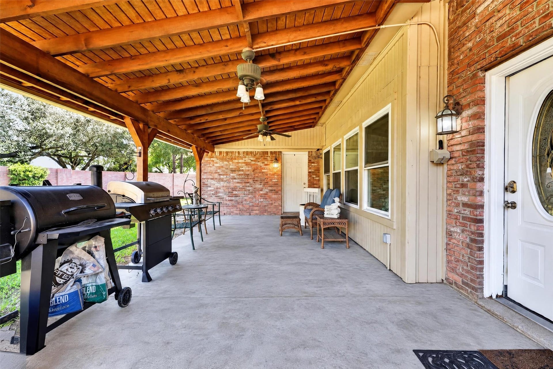 Covered back patio with door to and windows to living area