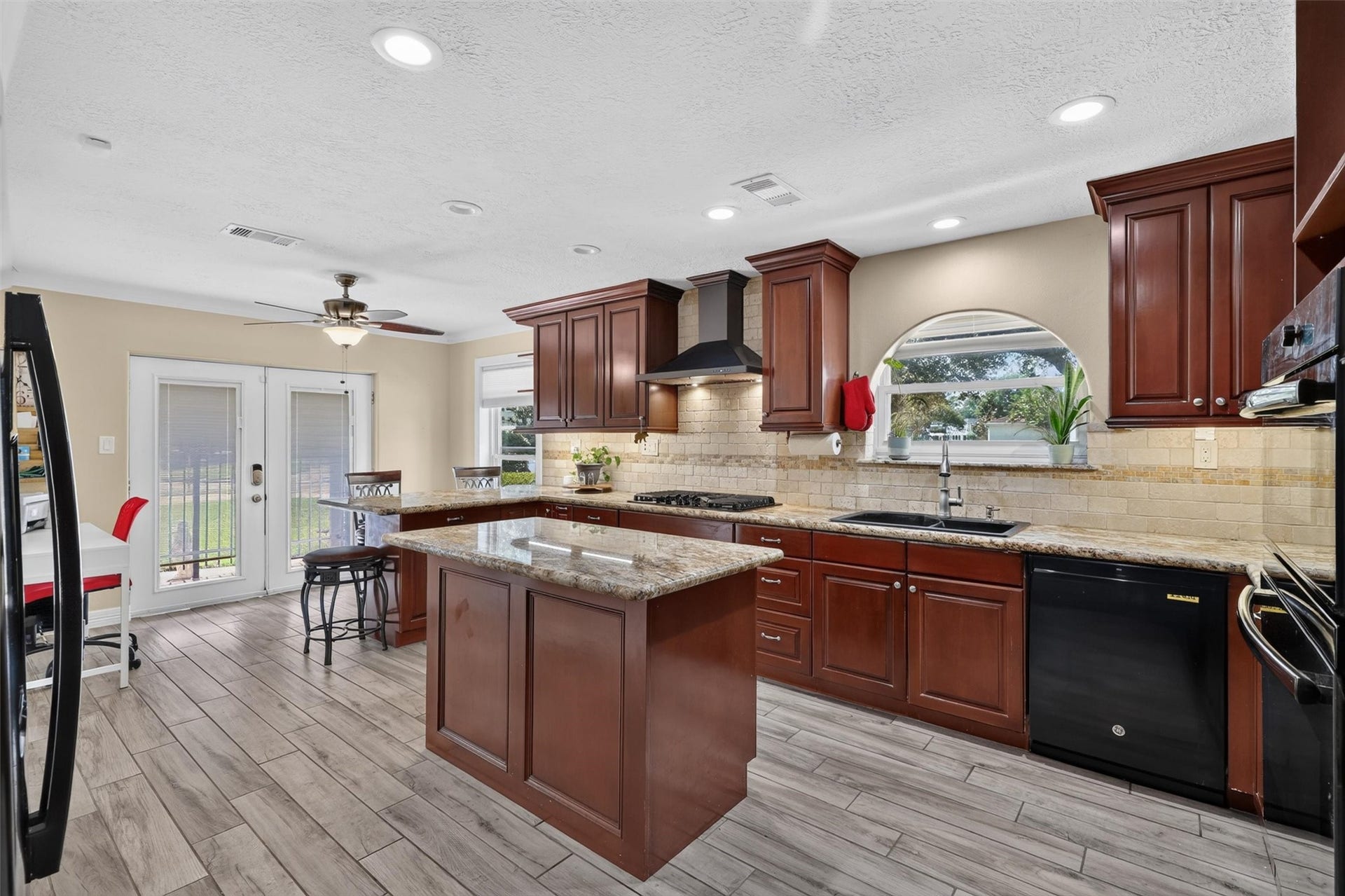 View of kitchen with door to side patio