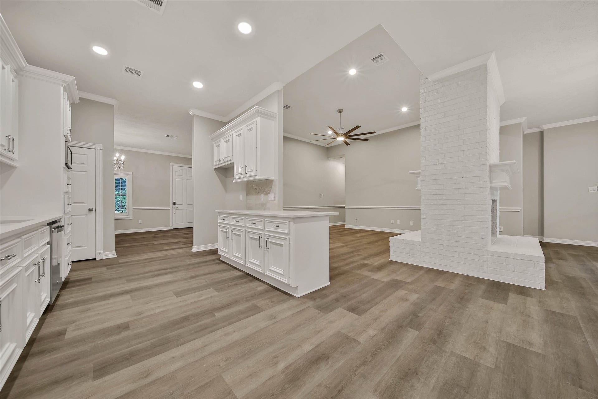 1125 W Stroker Road, #1125, Crosby, TX 77532 Kitchen and living area with double sided fireplace.