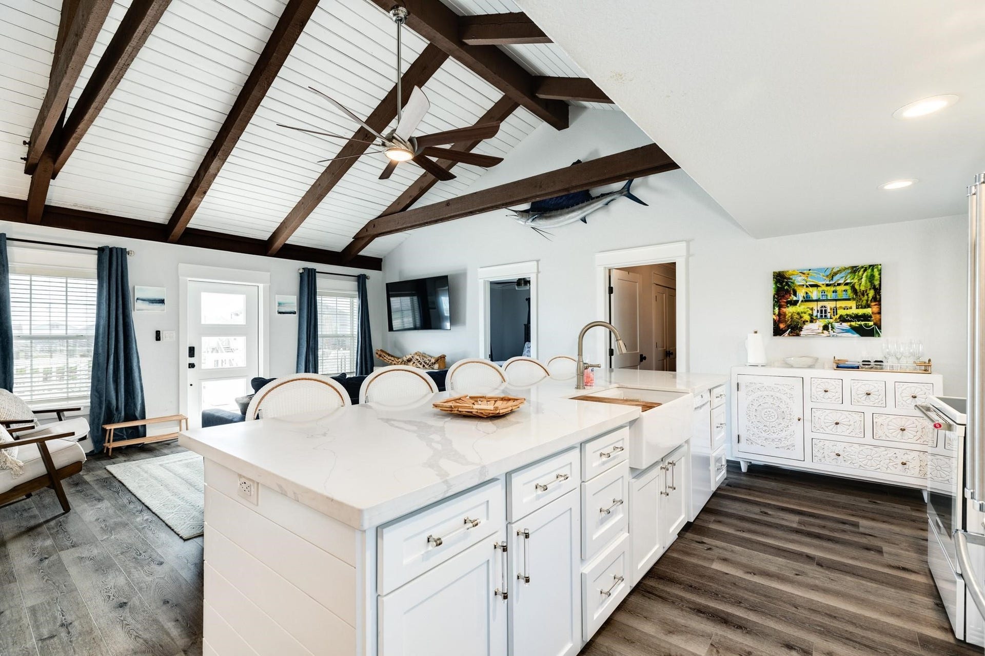 307 Angel Wing Street, Surfside Beach, TX 77541 The heart of the home! This stunning kitchen features a spacious island with seating for five, a charming farmhouse sink, and beautiful white quartz countertops. Perfect for gathering with family and friends.