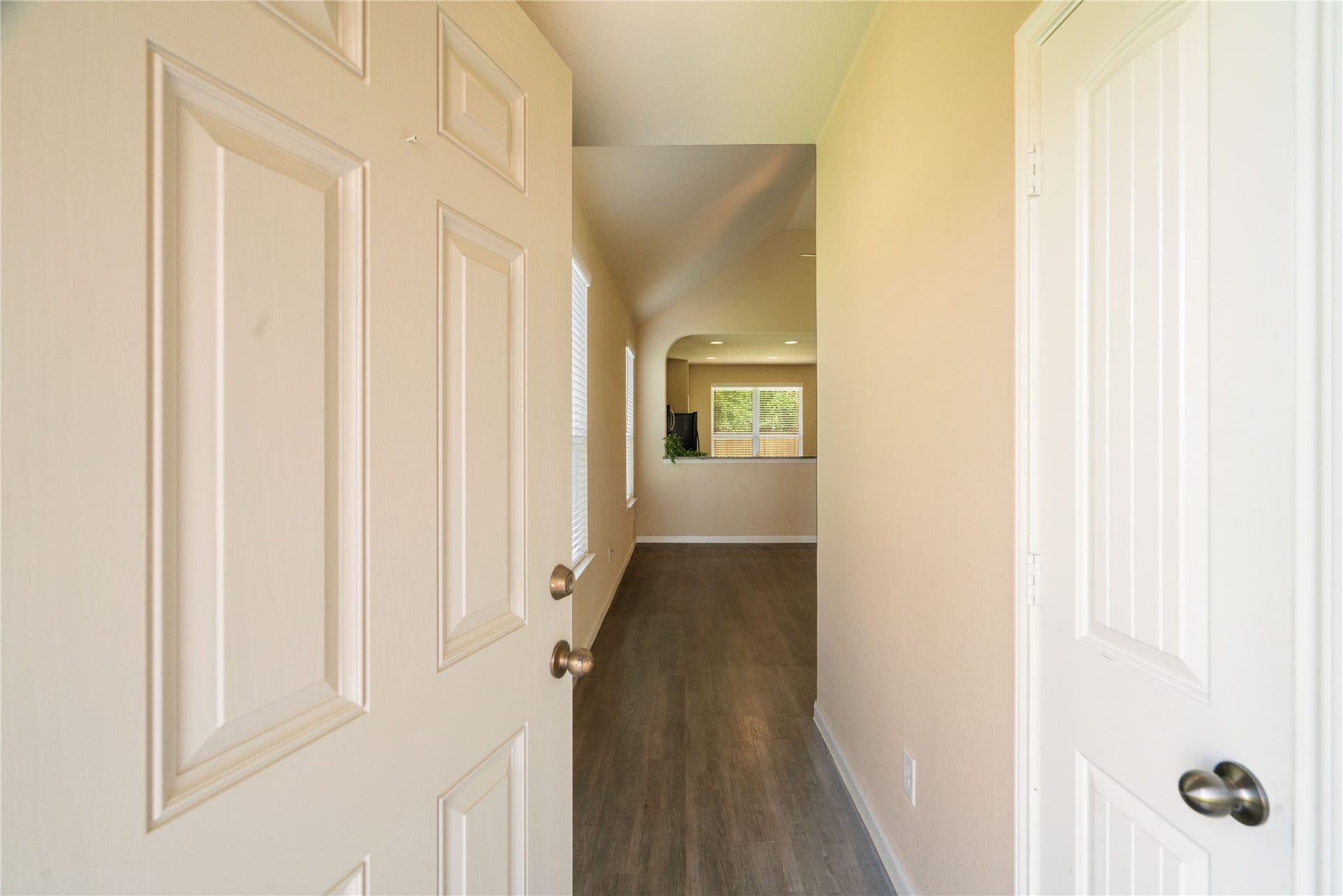Step inside to a bright, welcoming entry with durable flooring, neutral finishes, and an open sightline leading into the heart of the home.