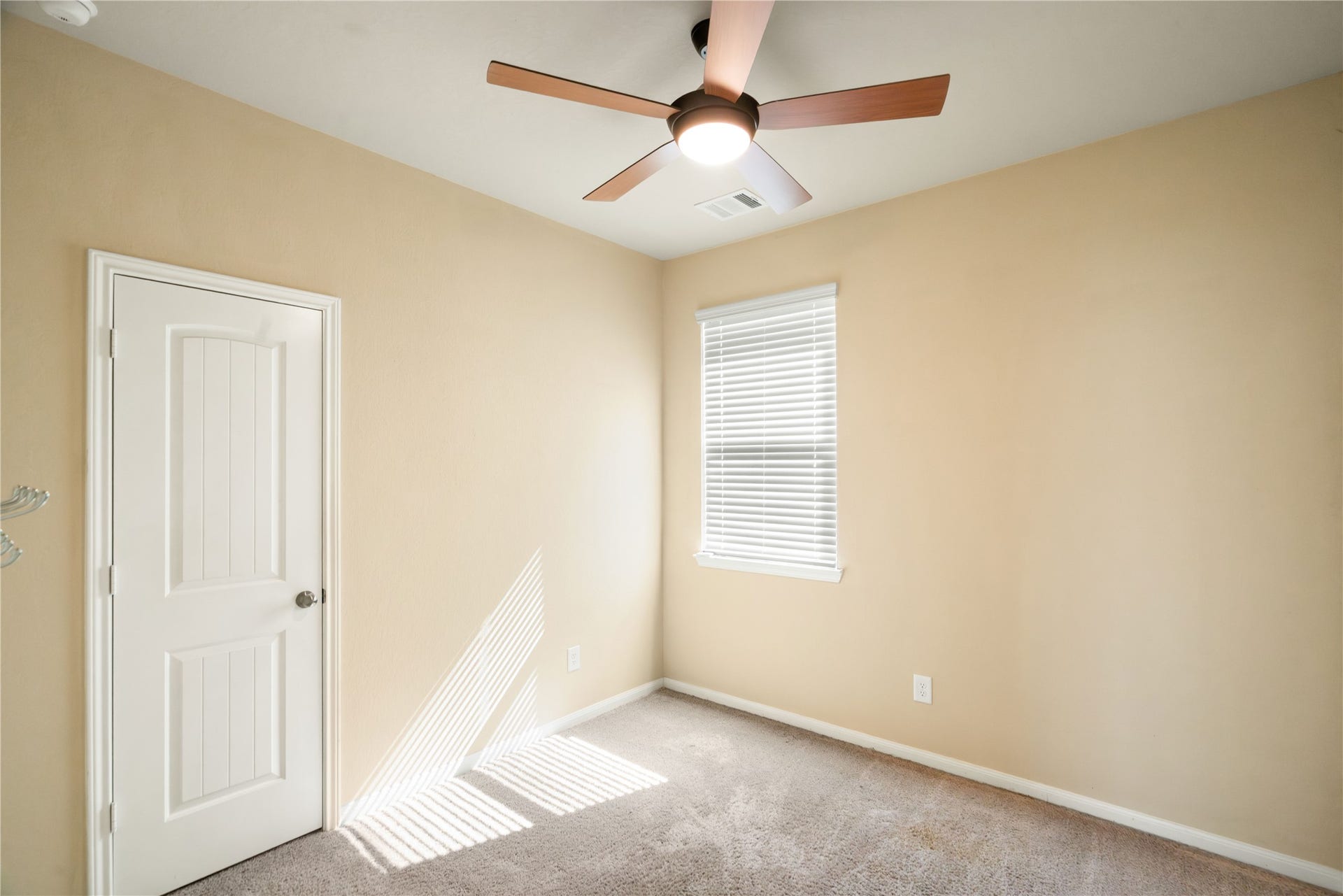 One of three secondary bedrooms. Neutral paint color continues through all secondary bedrooms.