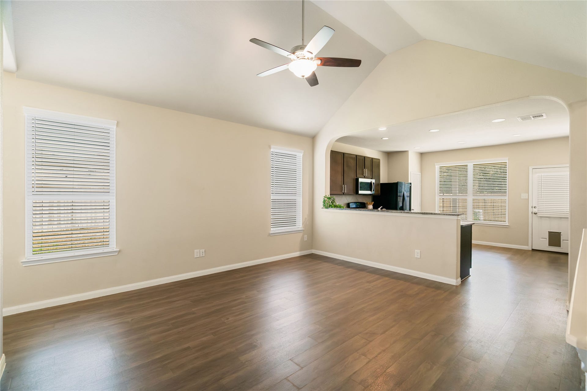 Open-concept living at its best with vaulted ceilings, abundant natural light, and seamless flow into the kitchen and dining areaperfect for everyday living and entertaining and view is nice and lush with the tree-lined backdrop and NO back neighbors!!