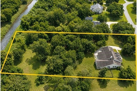 5202 Bessies Creek Trace, Fulshear, TX 77441 This birds-eye view showcases the natural beauty and the impressive scale of this incredible property, with a backyard that extends past even what the eye can see. Across the road is a Nature Reserve with a trail system that winds for miles.