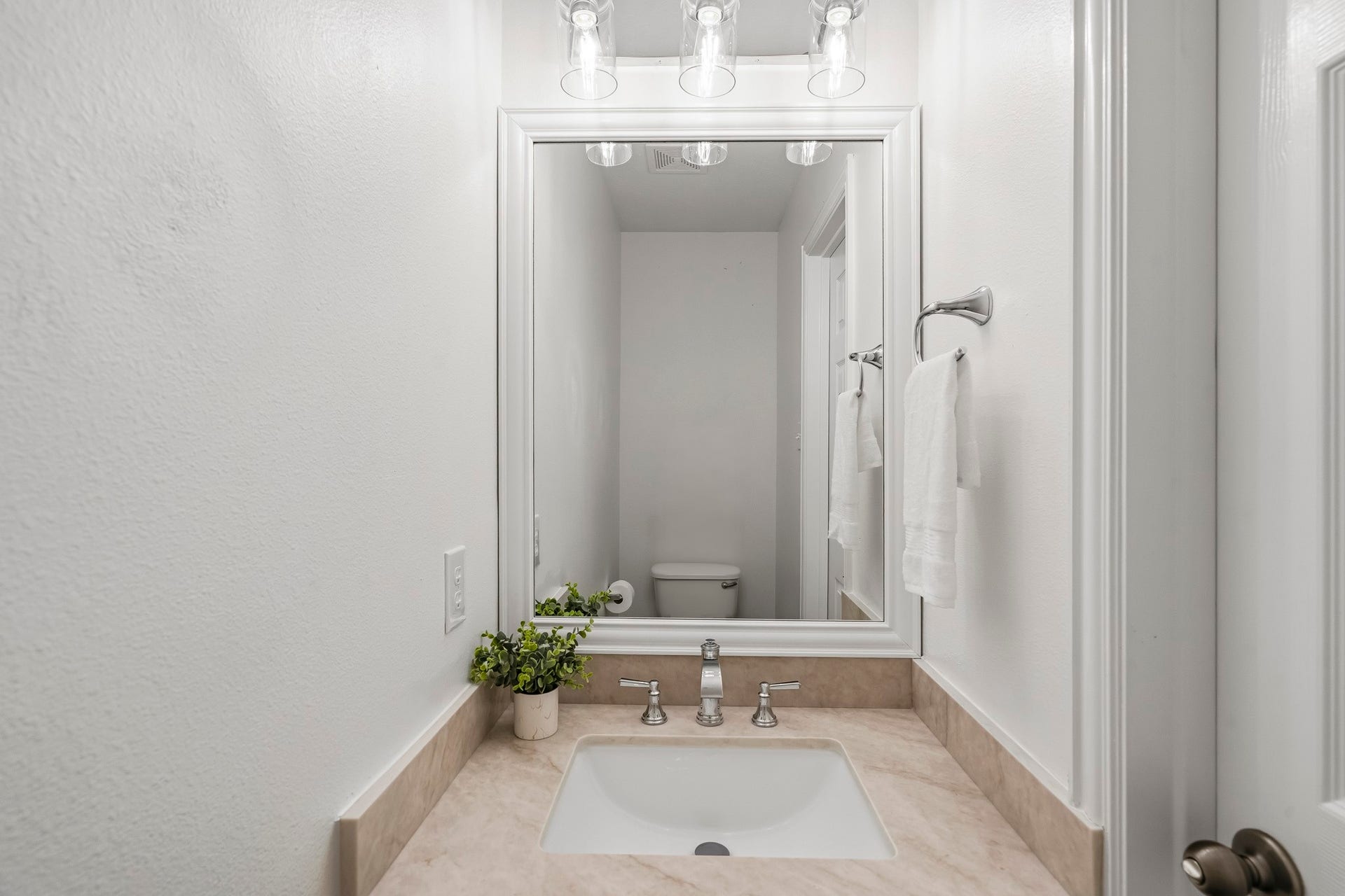 5202 Bessies Creek Trace, Fulshear, TX 77441 Serving the upstairs entertainment level, this stylish Half Bath is finished with an undermount sink, quartz countertop, and custom-framed mirror, creating a polished and cohesive aesthetic.