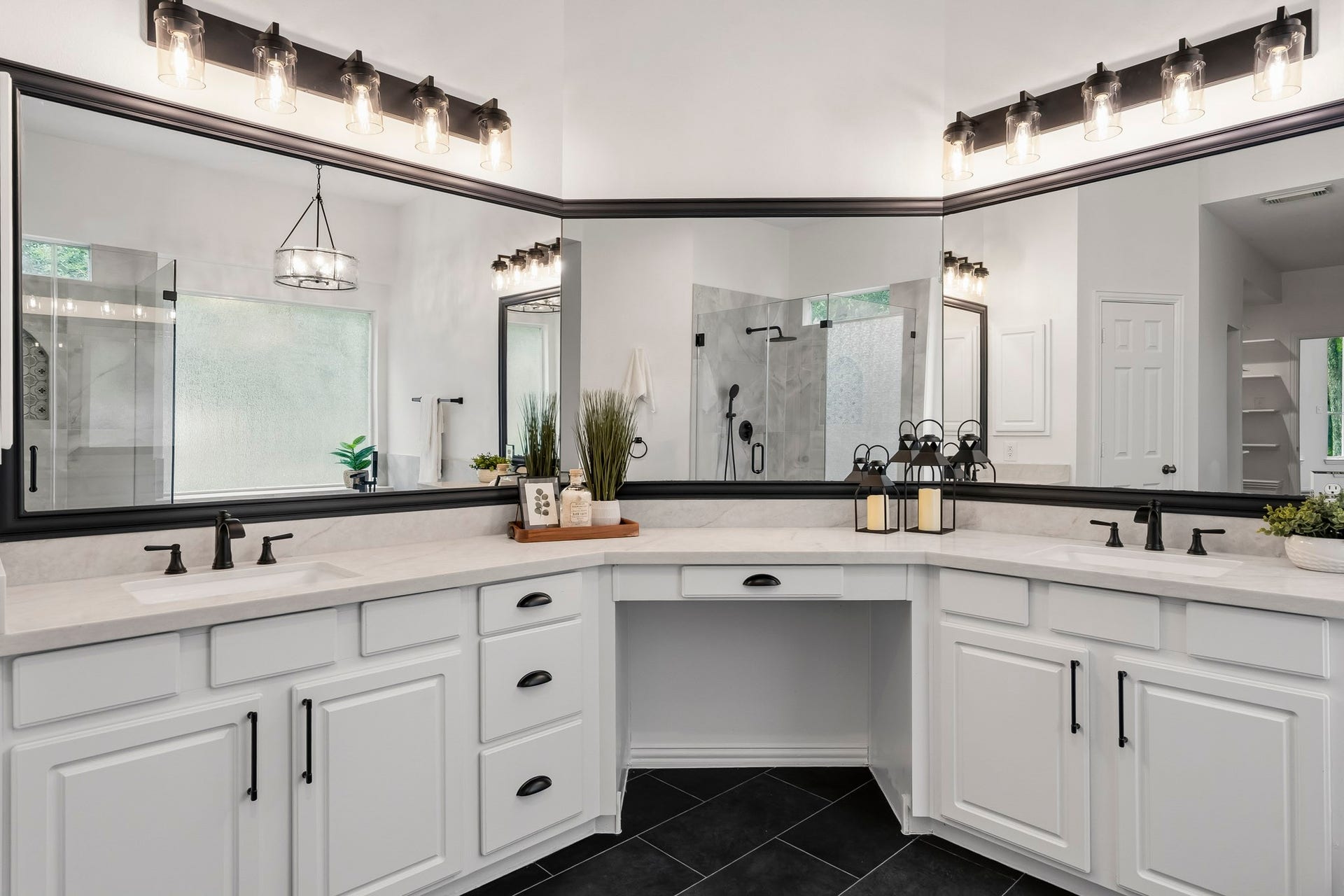 5202 Bessies Creek Trace, Fulshear, TX 77441 The white cabinetry is topped with luxurious taj mahal inspired quartz countertops and complemented by dual undermount sinks for both beauty and functionality. Matte black hardware provides a striking contemporary contrast, while a wrap-around custom-framed mirror adds a refined finishing touch, creating a spa-inspired retreat designed for everyday indulgence.