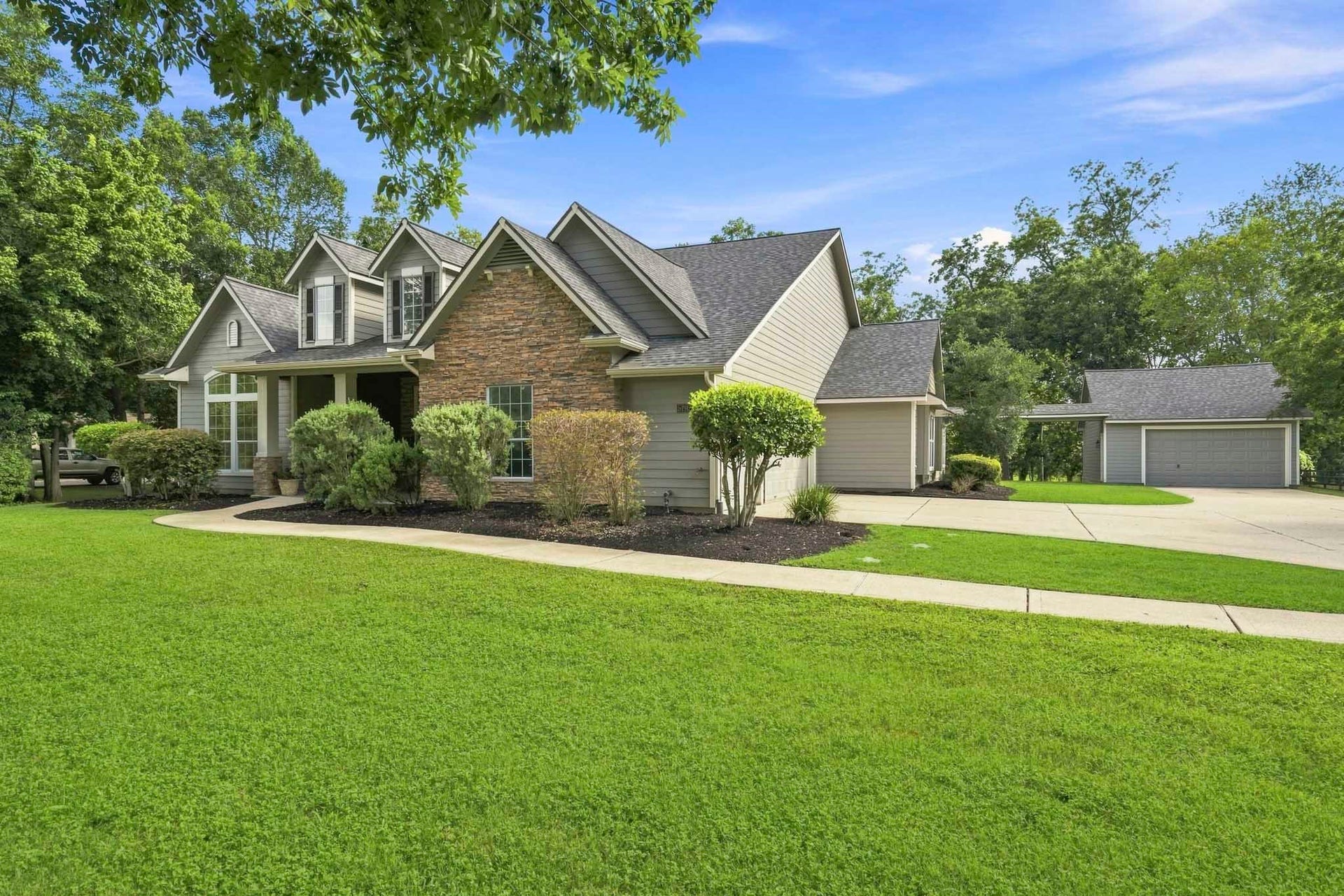 5202 Bessies Creek Trace, Fulshear, TX 77441 A story book setting is an apt description of this home that is set well back off the road and is nestled in amongst lush landscaping and sheltered from the sun by mature trees.