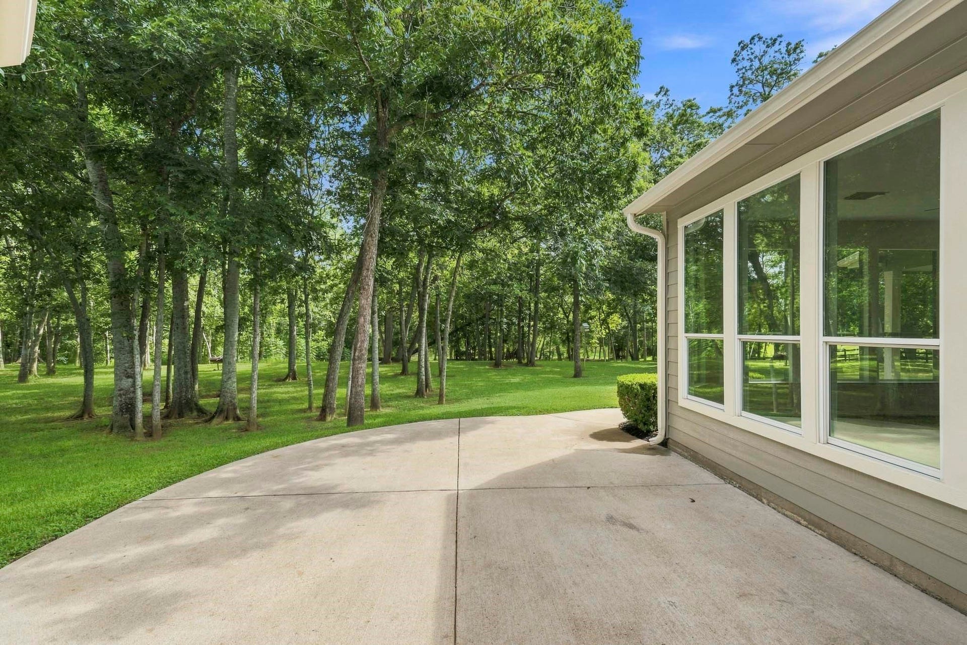 5202 Bessies Creek Trace, Fulshear, TX 77441 From the covered back Porch, enjoy slow mornings and peaceful evenings from the comfort of this private sanctuary where serene vista views are witnessed beneath the canopy of a forest of mature trees.