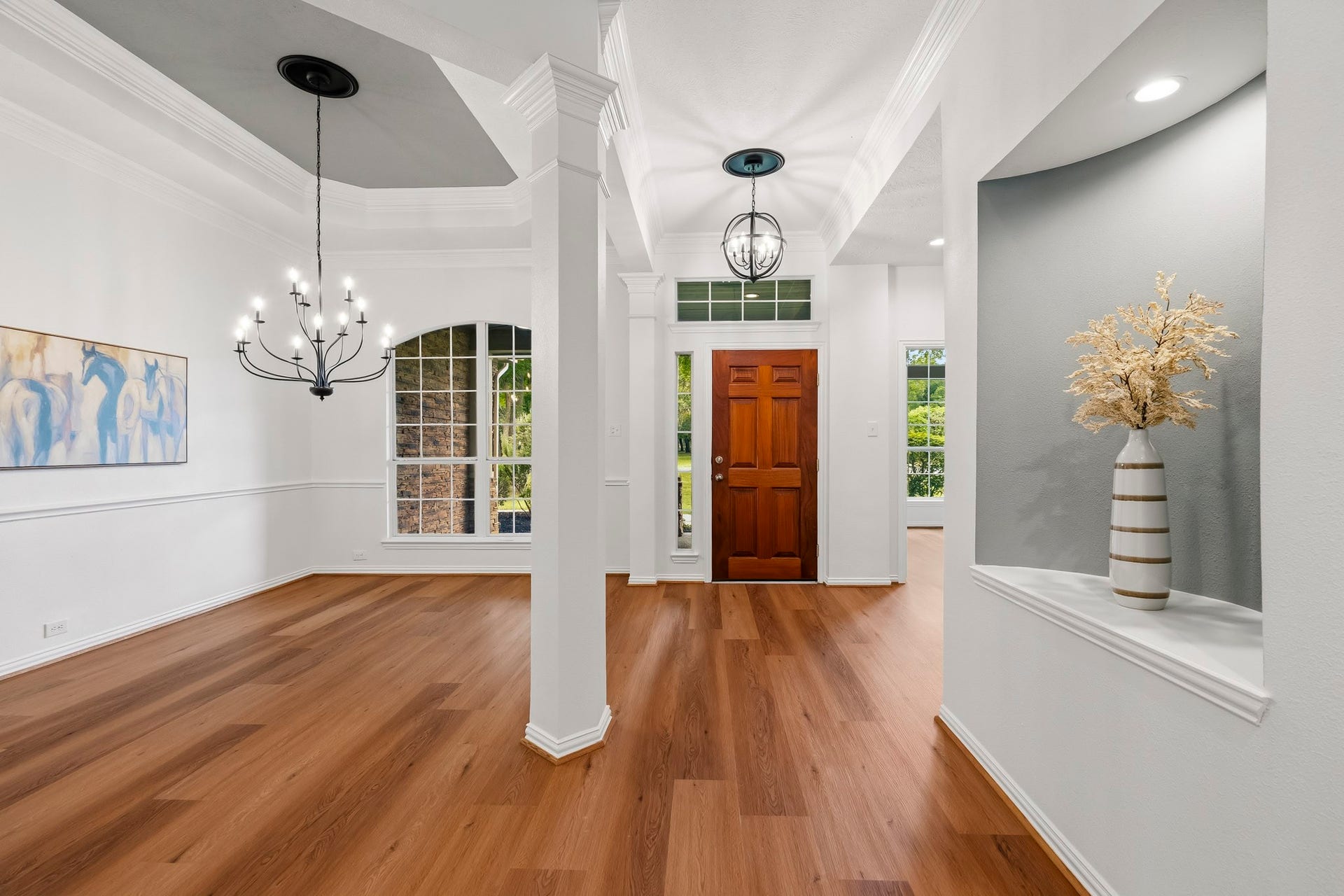 5202 Bessies Creek Trace, Fulshear, TX 77441 The Foyer makes a striking first impression with its spacious design and open sightlines that extend throughout the main living areas, creating an immediate sense of flow and connection. Natural light pours into the space through the sidelight and transom windows, enhancing its bright and welcoming atmosphere. A thoughtfully designed art niche serves as an elegant architectural accent, adding depth, character, and sophistication to this inviting entryway.