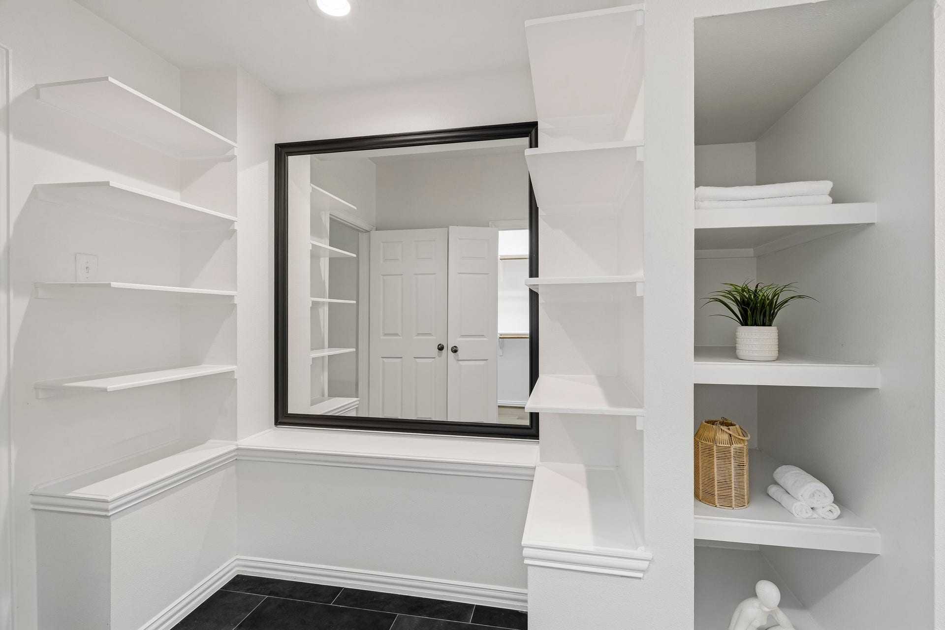 5202 Bessies Creek Trace, Fulshear, TX 77441 Located at the entrance to the Primary Bath, this thoughtfully designed storage area is complemented by a mirror, creating the perfect place for final touch-ups and one last glance before stepping into your day.