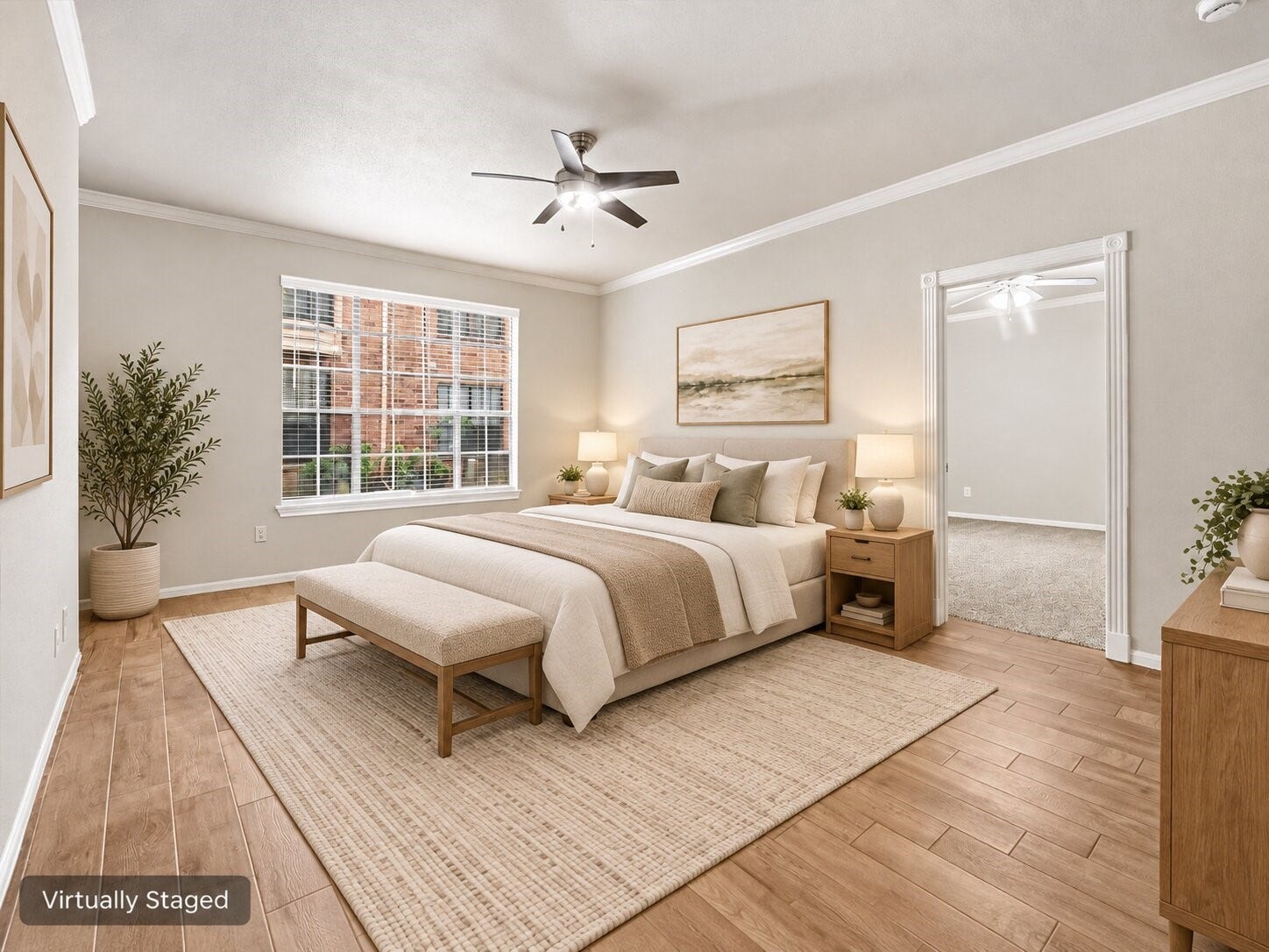Alternate view of the secondary bedroom highlighting the spacious layout, large window, ceiling fan, and adjoining access. Virtually staged for visualization purposes.