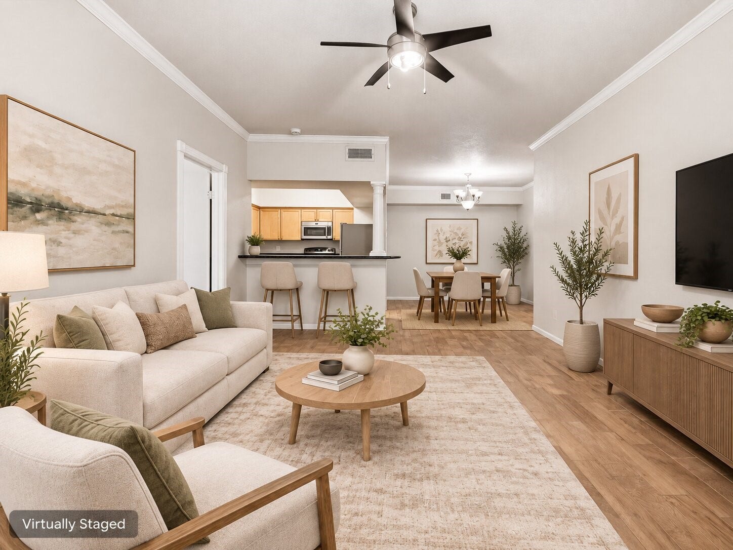 Open living area overlooking the kitchen and dining space, featuring wood-look flooring, breakfast bar seating, and a flexible floor plan. Virtually staged for visualization purposes.