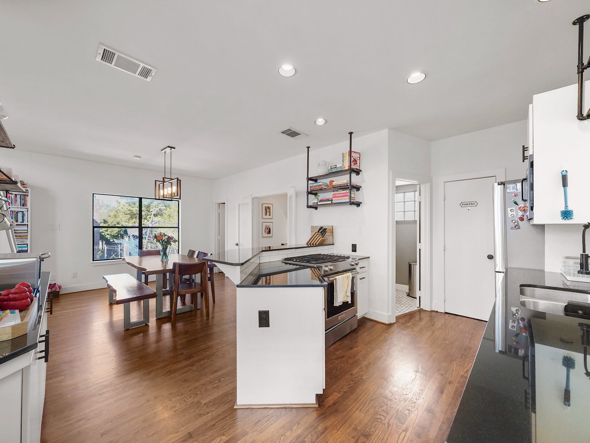 1231 Jackson Boulevard, Houston, TX 77006 This inviting space boasts a seamless flow from the kitchen to the connected dining area, perfect for effortless entertaining and everyday living.