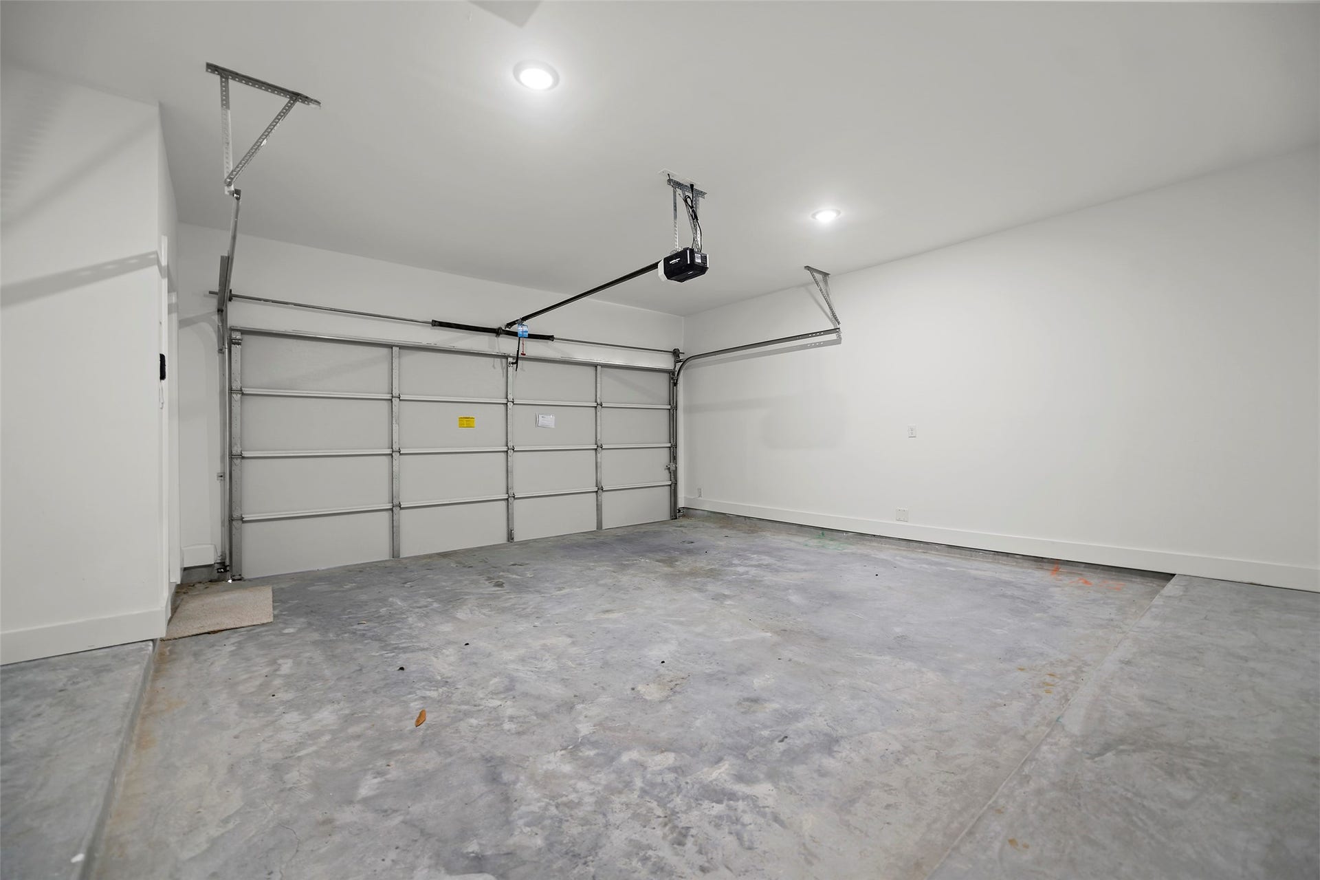 870 W Little York Road, #A, Houston, TX 77091 This is a spacious, clean garage with concrete floor and WiFi Automatic door opener, offering ample room for parking and storage.