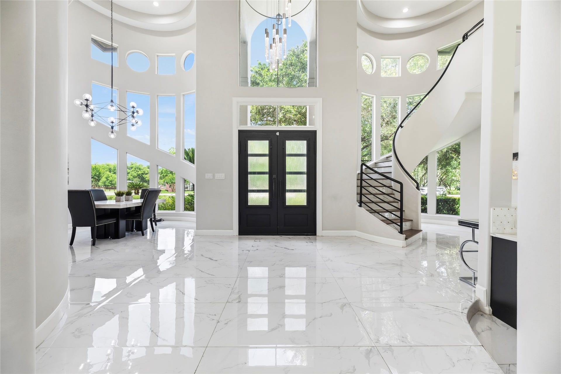 23 Westpoint Drive, Missouri City, TX 77459 Dramatic two-story foyer with designer lighting, sweeping staircase, and floor-to-ceiling windows.