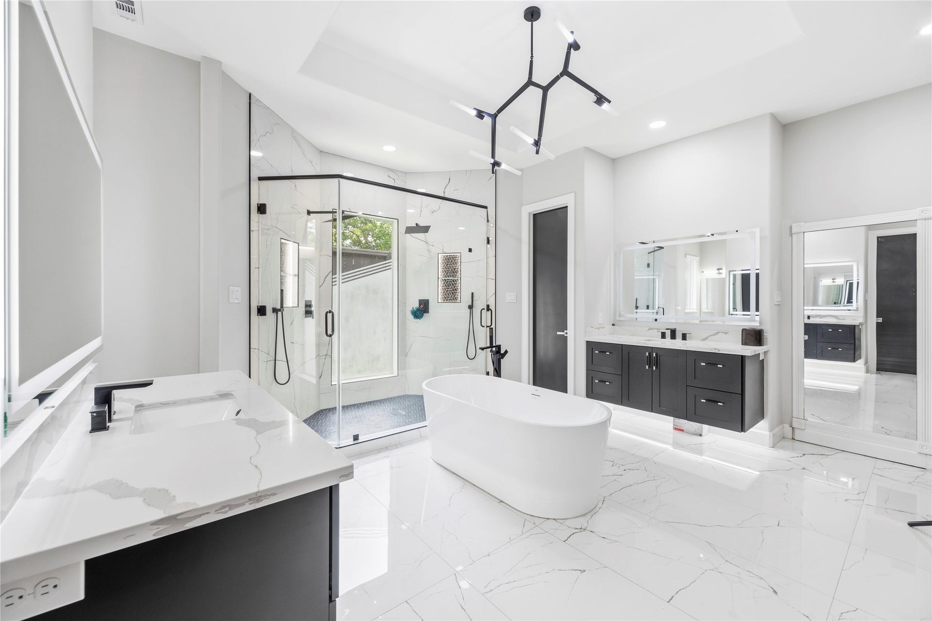 23 Westpoint Drive, Missouri City, TX 77459 Luxurious bath with dual vanities, freestanding soaking tub, and designer finishes.