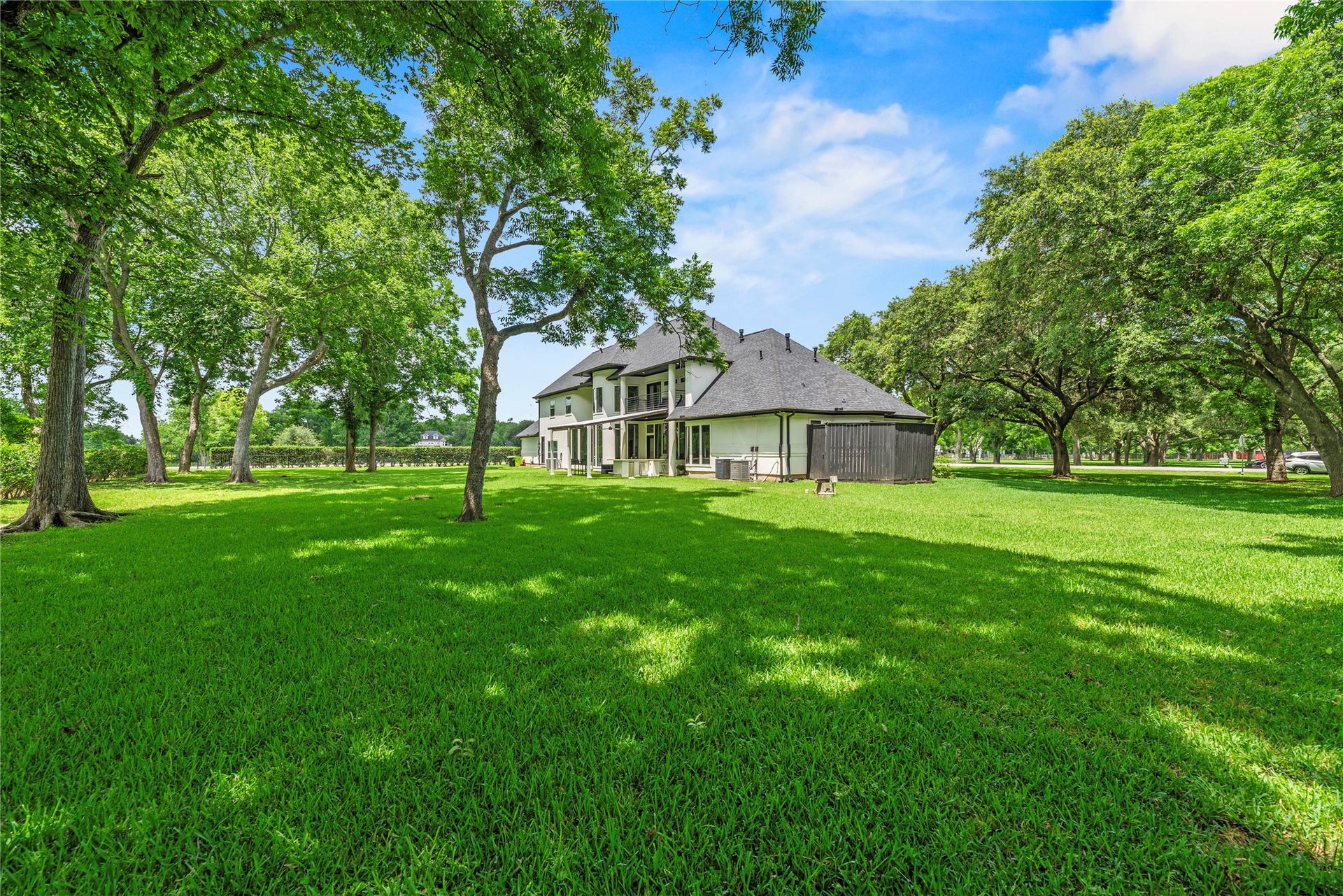 23 Westpoint Drive, Missouri City, TX 77459 Park-like backyard framed by towering trees, offering exceptional privacy and room to play, gather, and explore.