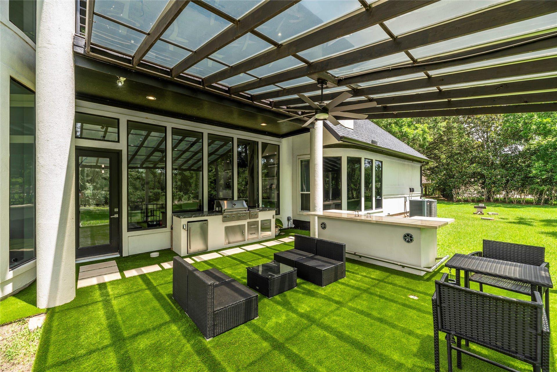 23 Westpoint Drive, Missouri City, TX 77459 Covered outdoor retreat featuring a summer kitchen, serving bar, and generous space for year-round entertaining.