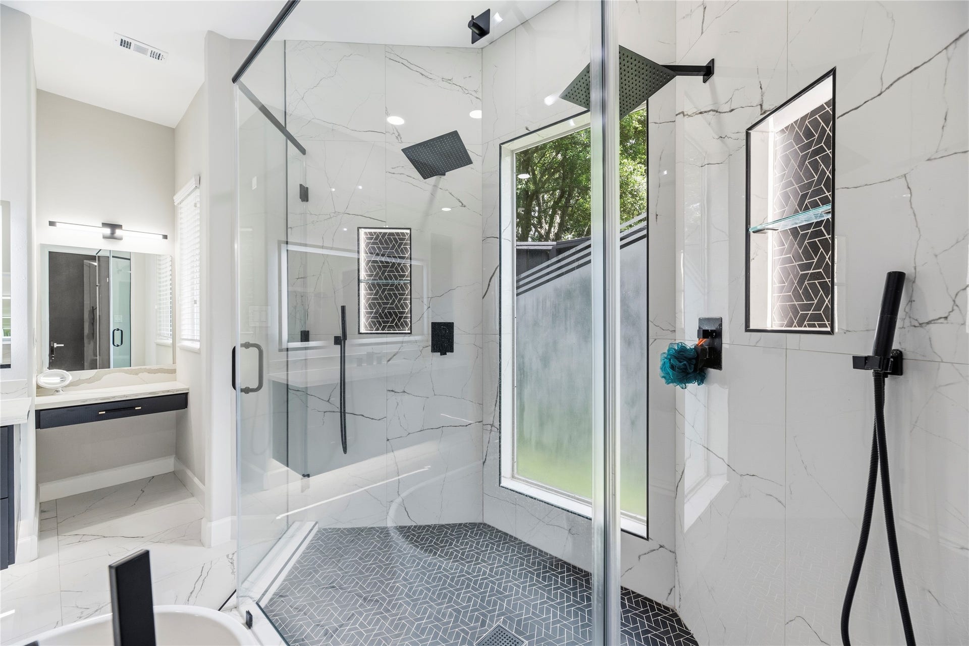 23 Westpoint Drive, Missouri City, TX 77459 Stunning oversized shower with floor-to-ceiling tile, dual showerheads, and elegant custom details.