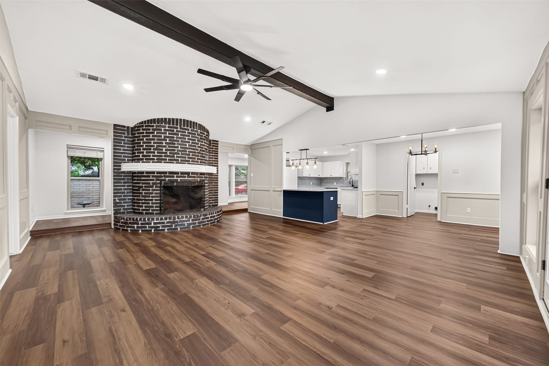 Bright open-concept layout connecting the living room, kitchen, and dining space