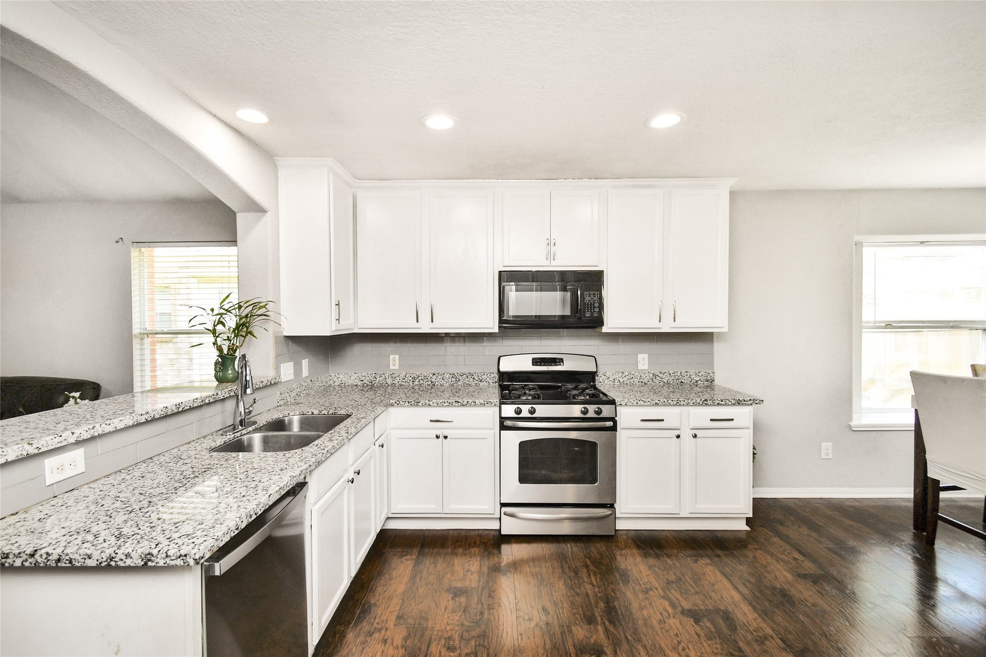 2319 Blue Reef Drive, Katy, TX 77449 Well appointed kitchen featuring crisp white cabinets, granite counters, and a gas range.