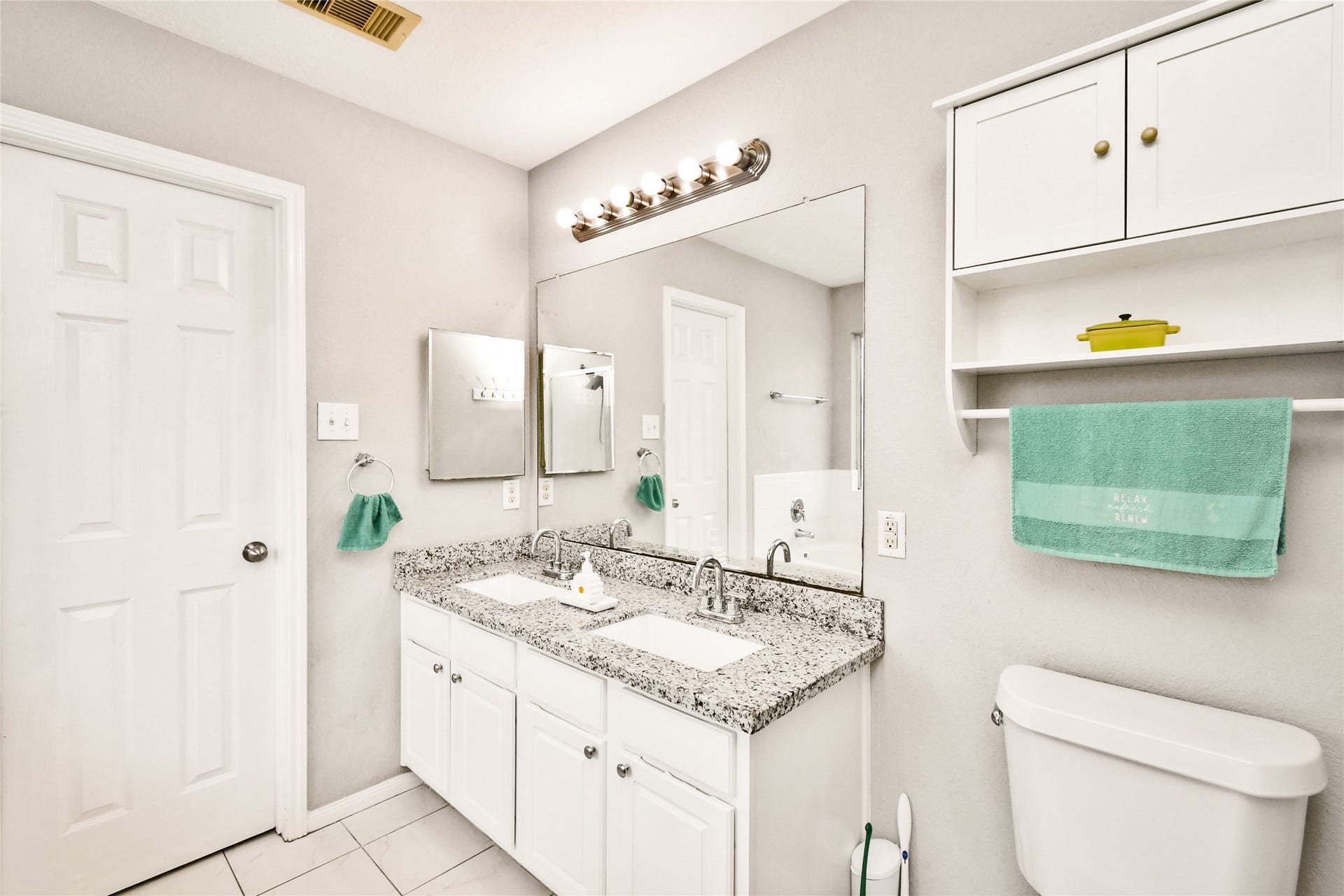 2319 Blue Reef Drive, Katy, TX 77449 Bright en suite bathroom with double sinks, granite countertops, and ample storage.