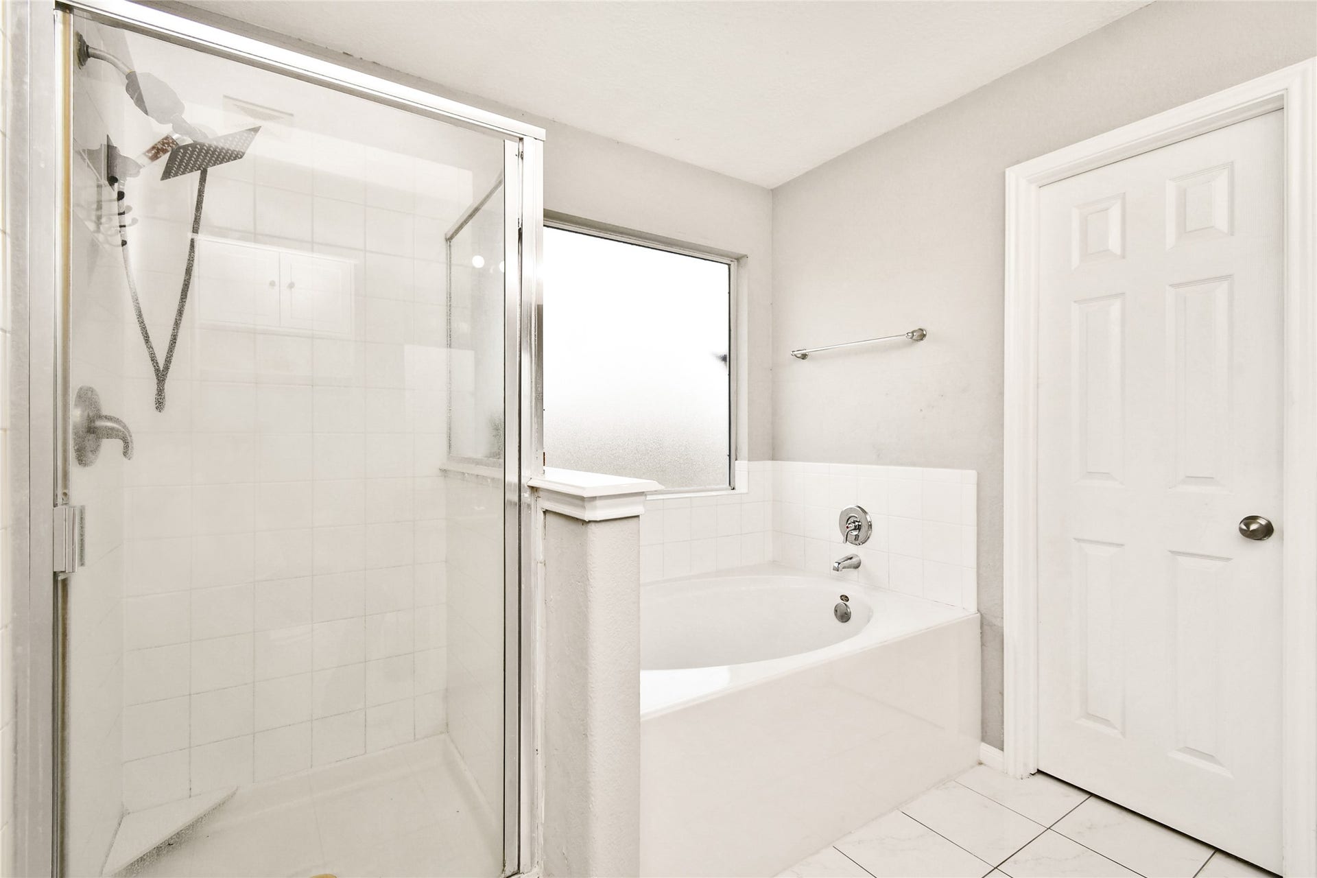 2319 Blue Reef Drive, Katy, TX 77449 Relaxing en suite featuring a separate glass shower and a deep soaking tub with tiled surround.