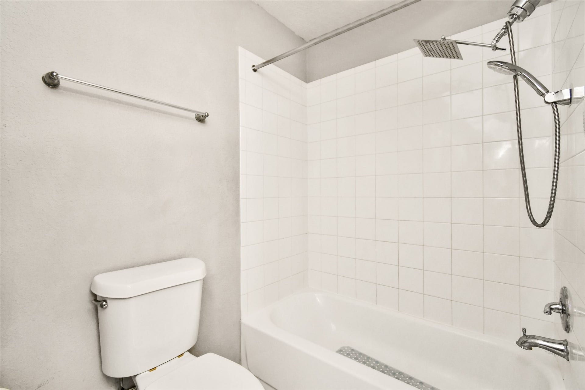 2319 Blue Reef Drive, Katy, TX 77449 Clean tub and shower combo with tile surround and a convenient rain shower head.