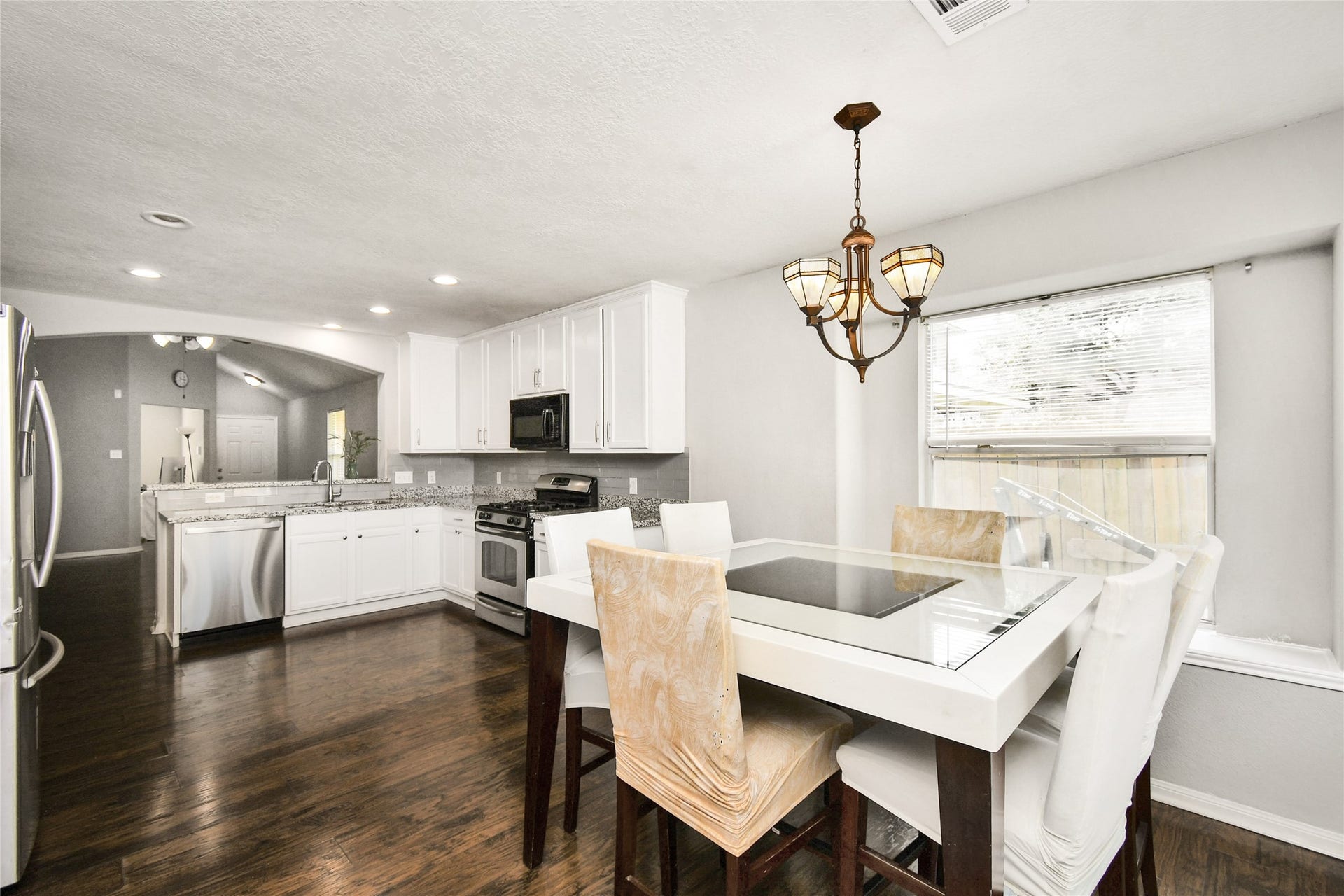 2319 Blue Reef Drive, Katy, TX 77449 Charming breakfast nook with pendant lighting and a clear view into the fully equipped kitchen.