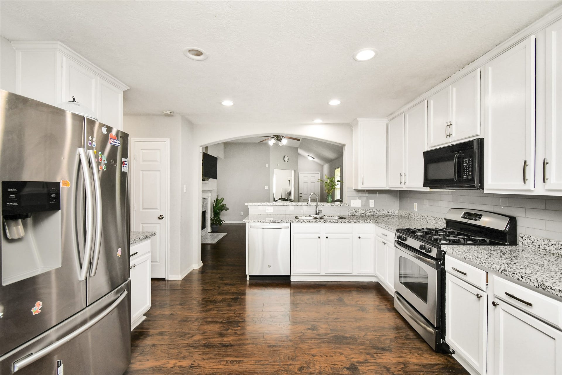 2319 Blue Reef Drive, Katy, TX 77449 Open concept kitchen with stainless steel appliances flowing seamlessly into the living room.