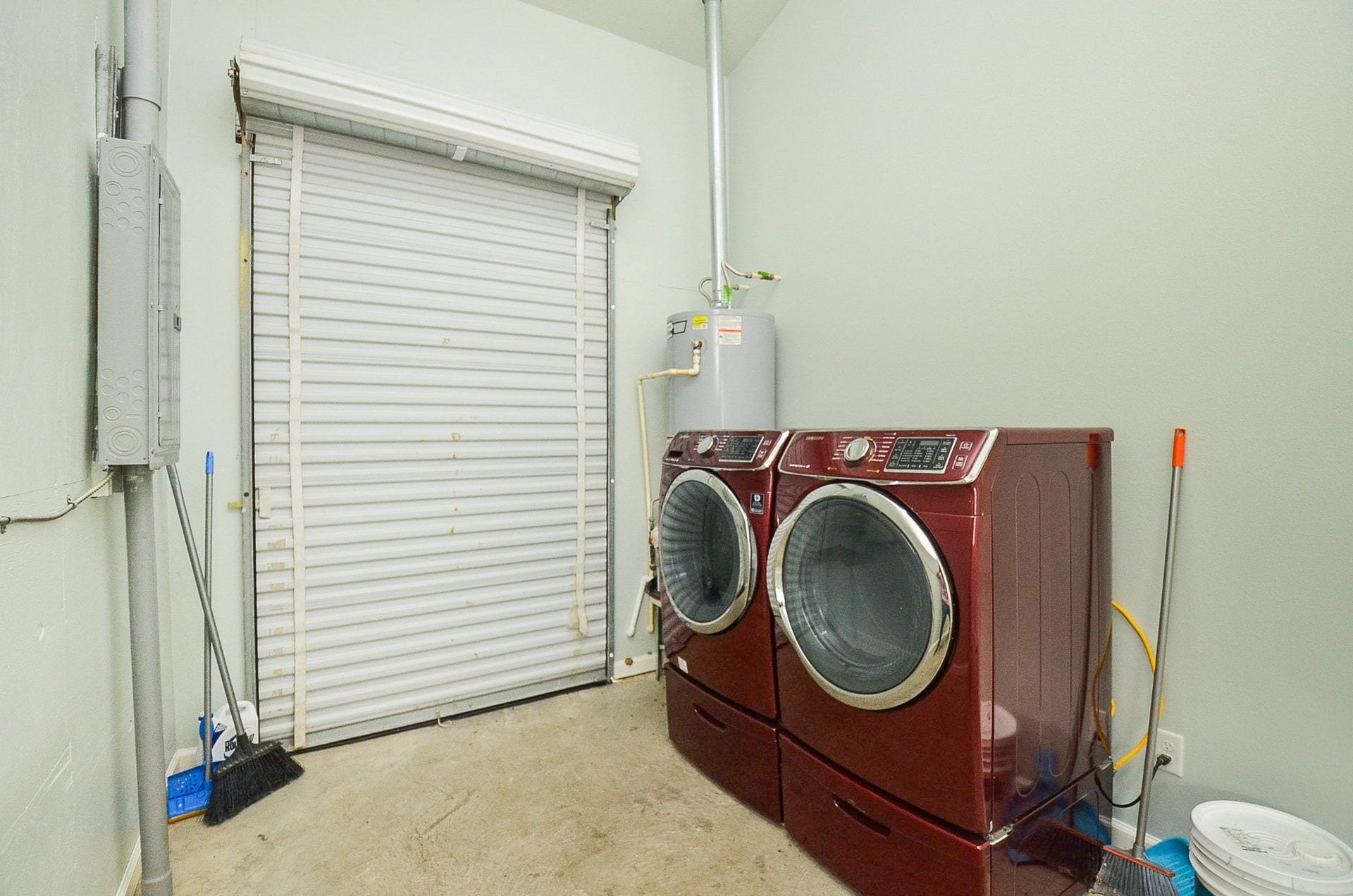 The roomy utility room easily welcomes dual laundry appliances and household storage.