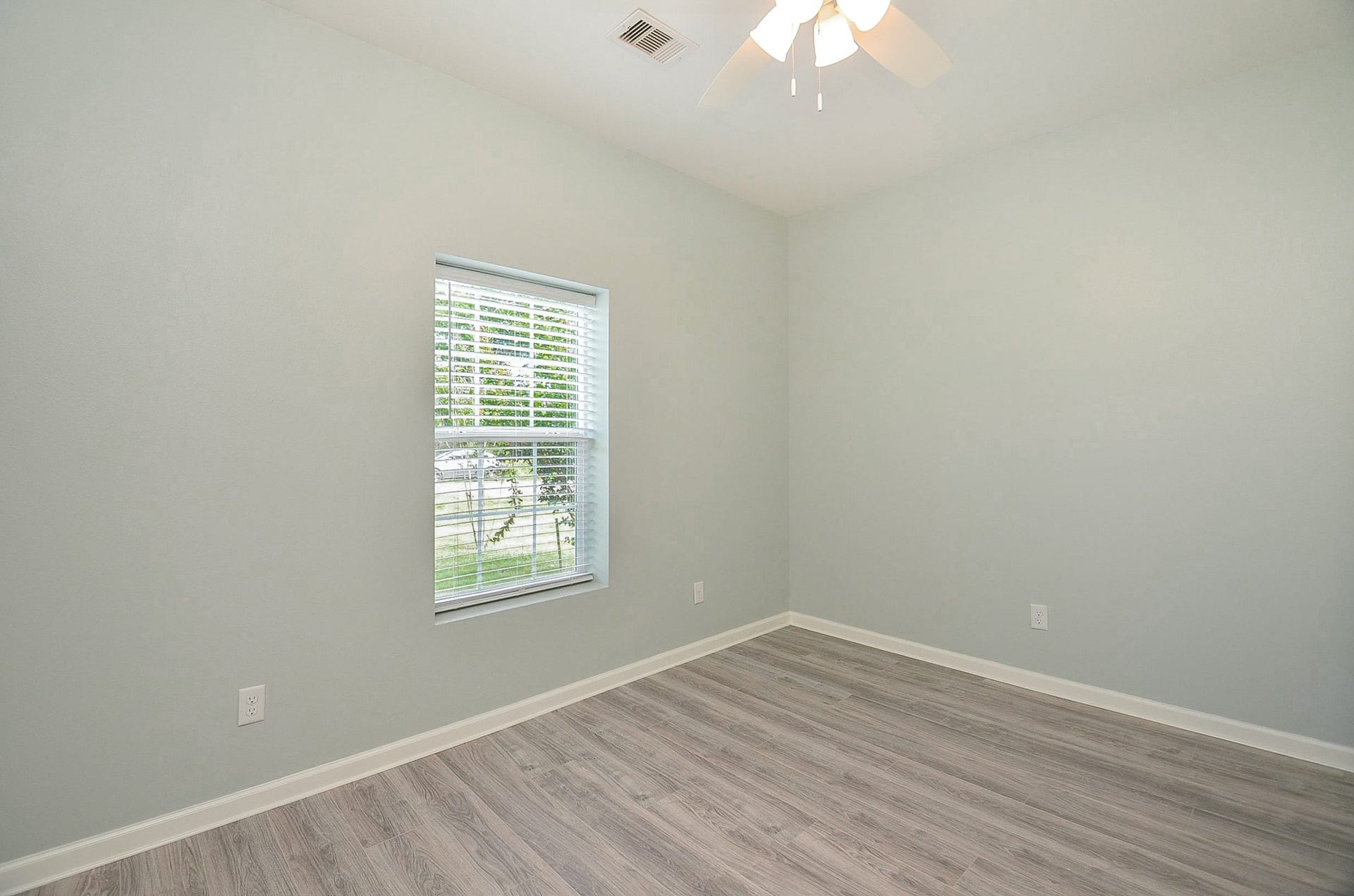Primary (or secondary?) bedroom welcomes natural light.