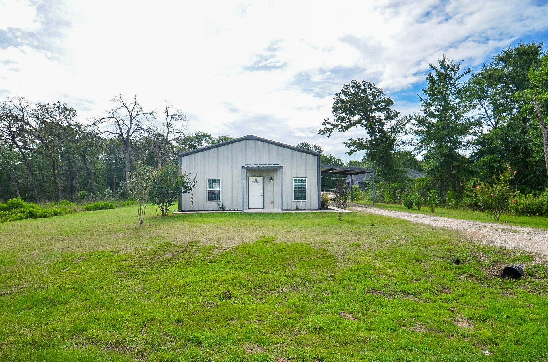 Blue skies above and natural greenery below surround this "Barndominium" --- a new phrase in rural real estate speak --- to denote a structural combination of barn/condo open space offering an exciting modern blend of contemporary comfort and relaxing country living.