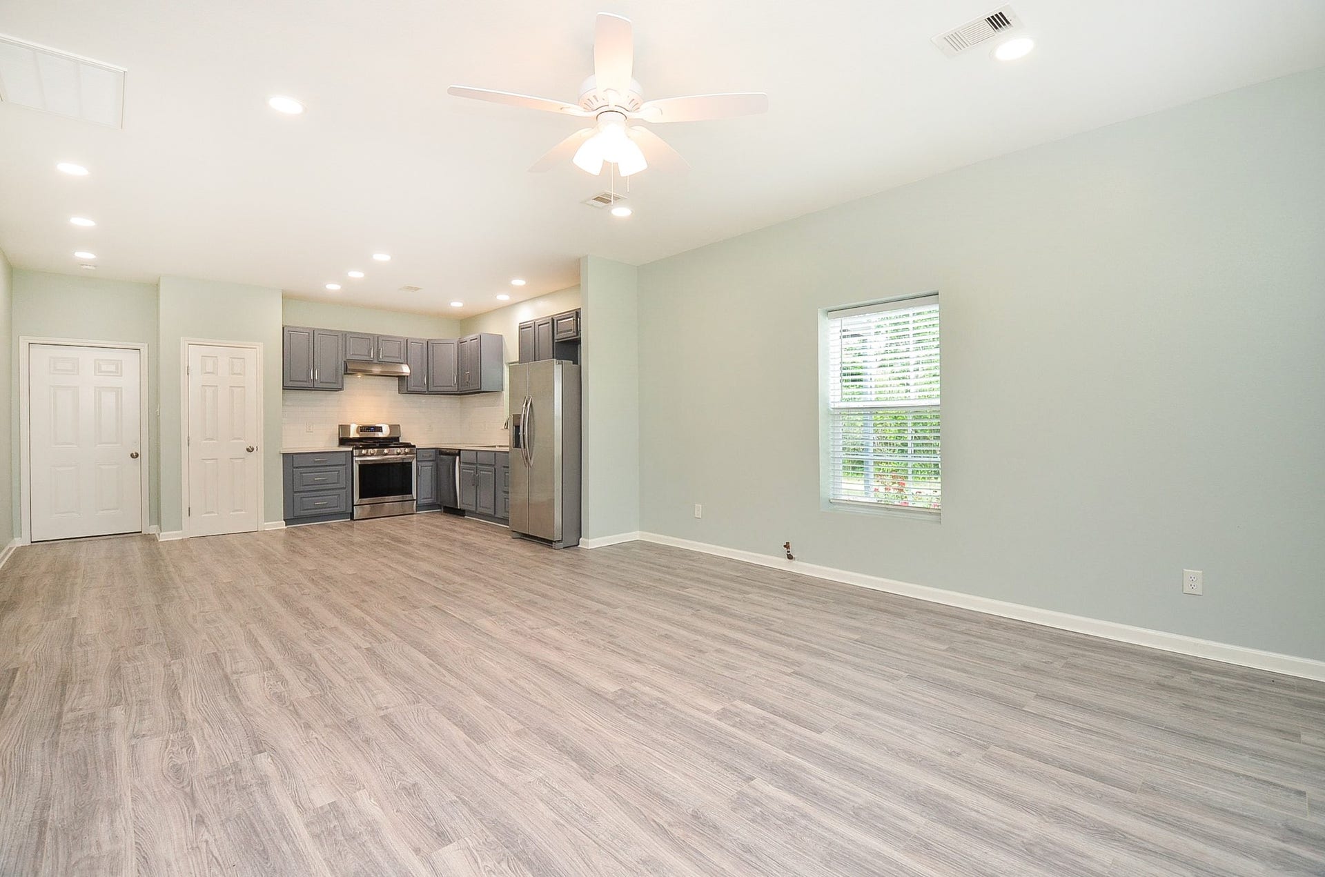 This is the wide open view from front entry into living/family area; possible dining area and kitchen.