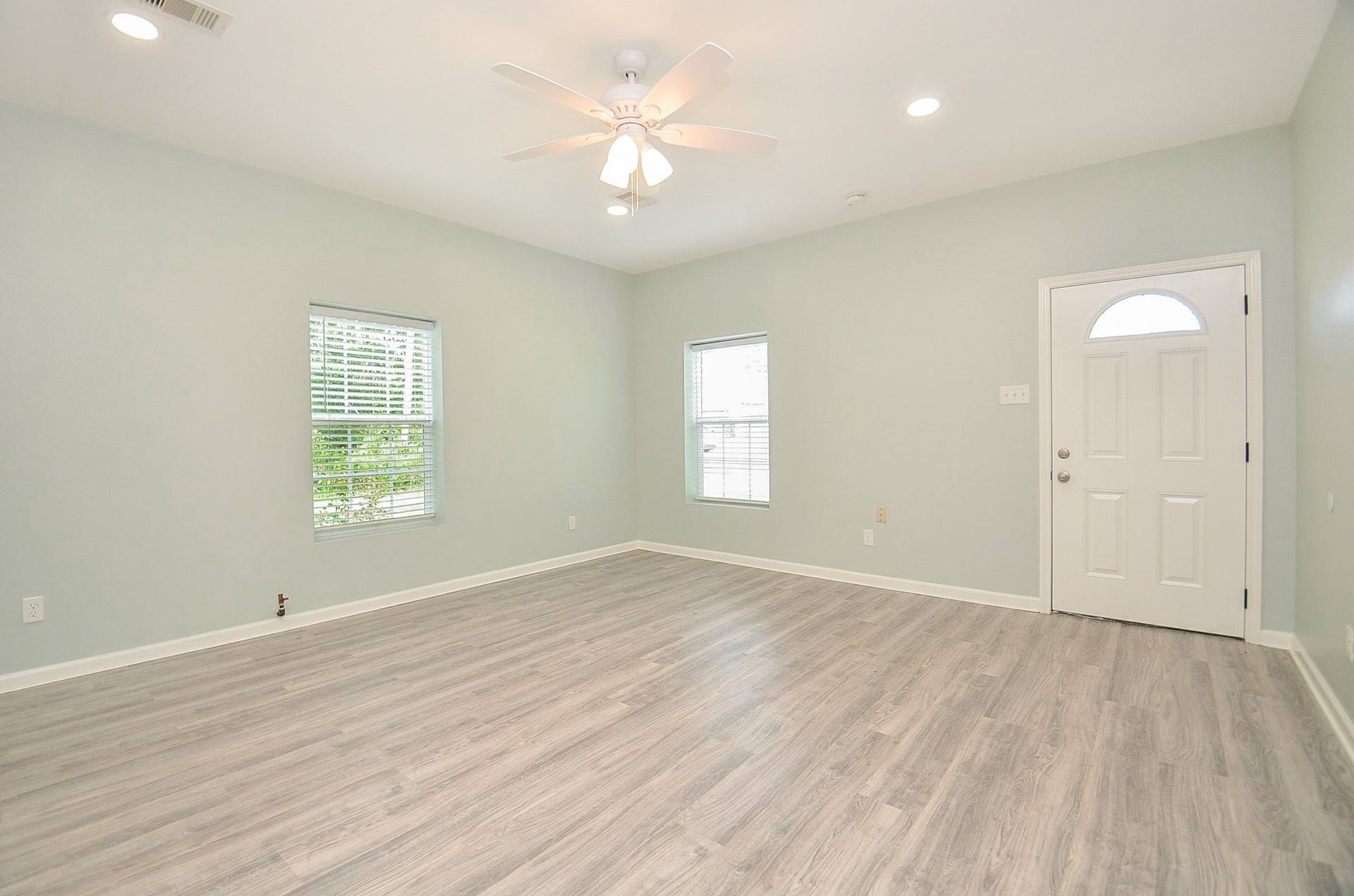 High ceiling, tremendous wall and vinyl plank floor space (there's no carpeting throughout) and nice natural light brighten the living/family area, right off the main entrance.