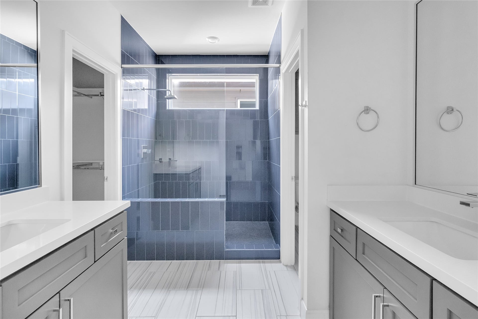 Double vanity, private restroom area, and storage closet.