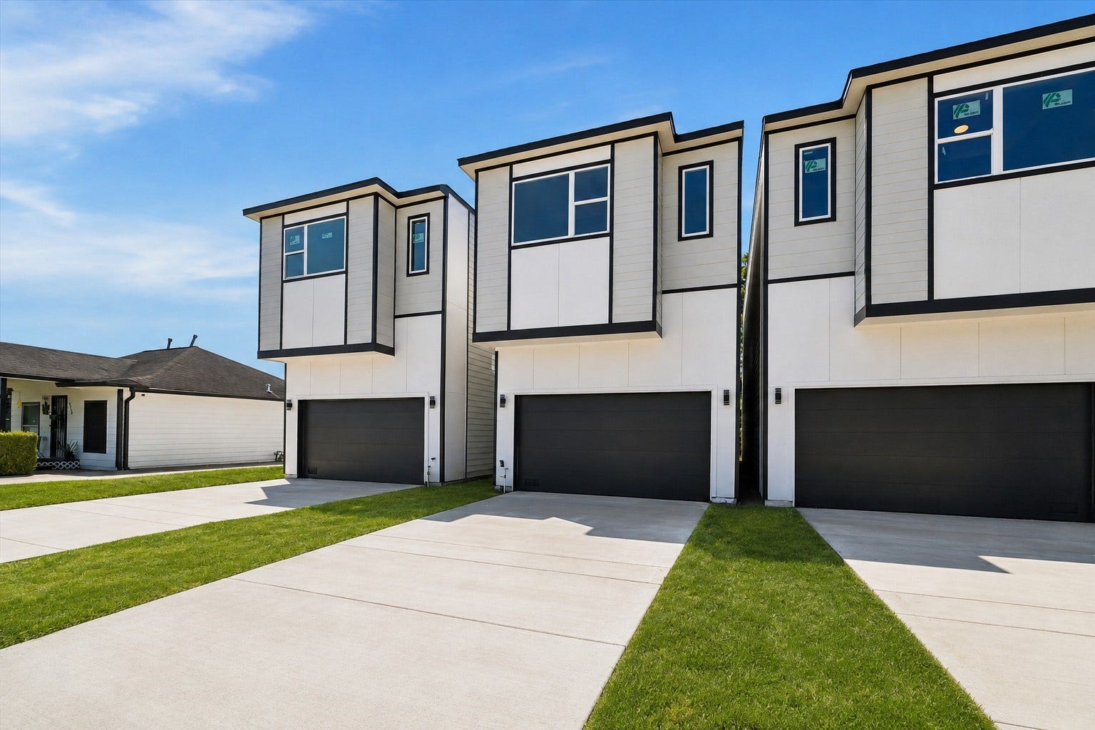 5310 Salina Street, Houston, TX 77026 Contemporary curb appeal sets the tone for this modern two-story home, featuring clean architectural lines, crisp white siding, bold black trim, and an attached garage. Large upper-level windows enhance the striking exterior design, while the private driveway provides convenient off-street parking. The streamlined faade creates a fresh, sophisticated first impression with a distinctly urban feel. This photo has been virtually staged for visual reference.