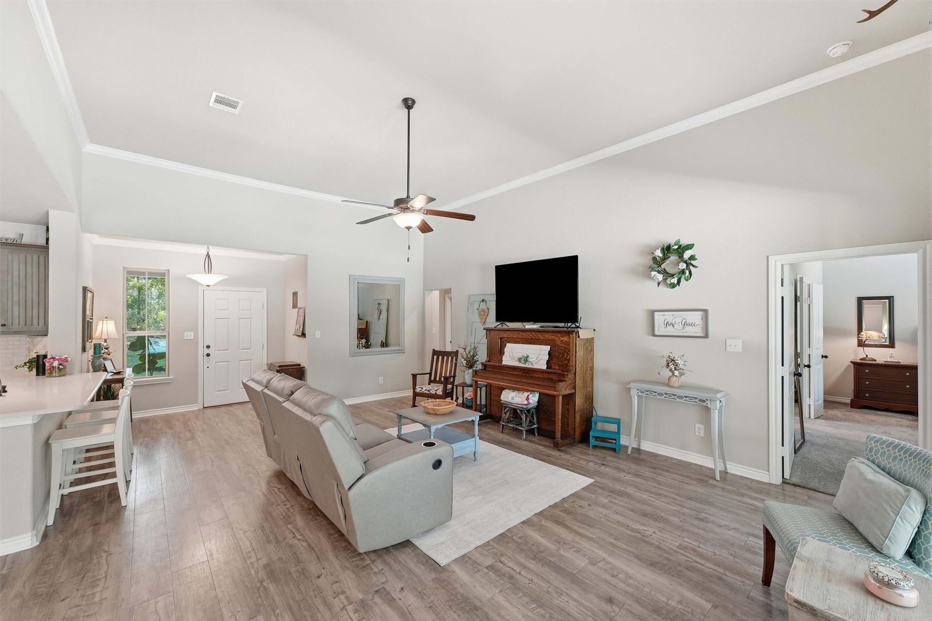 Durable and stylish flooring throughout living areas, crown molding, ceiling fans and a huge back wall for your media and furnishings.