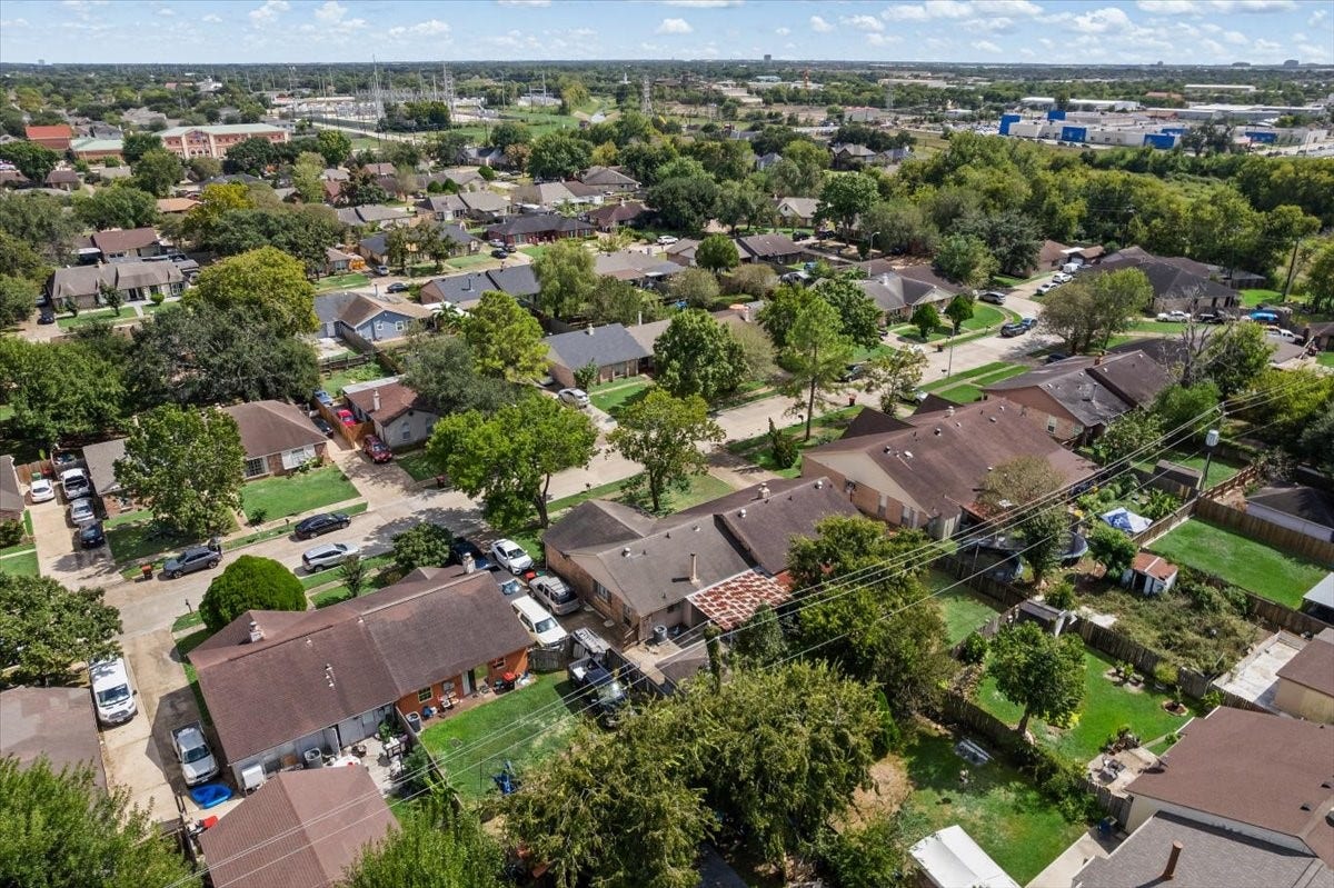 9522 Wellsworth Drive, Houston, TX 77083 Birds-eye view of the home, its mature trees, and generous lot