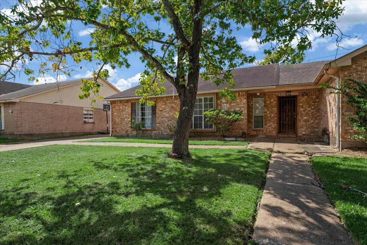 9522 Wellsworth Drive, Houston, TX 77083 Brick duplex exterior with large oak tree, manicured lawn, and separate front walkway